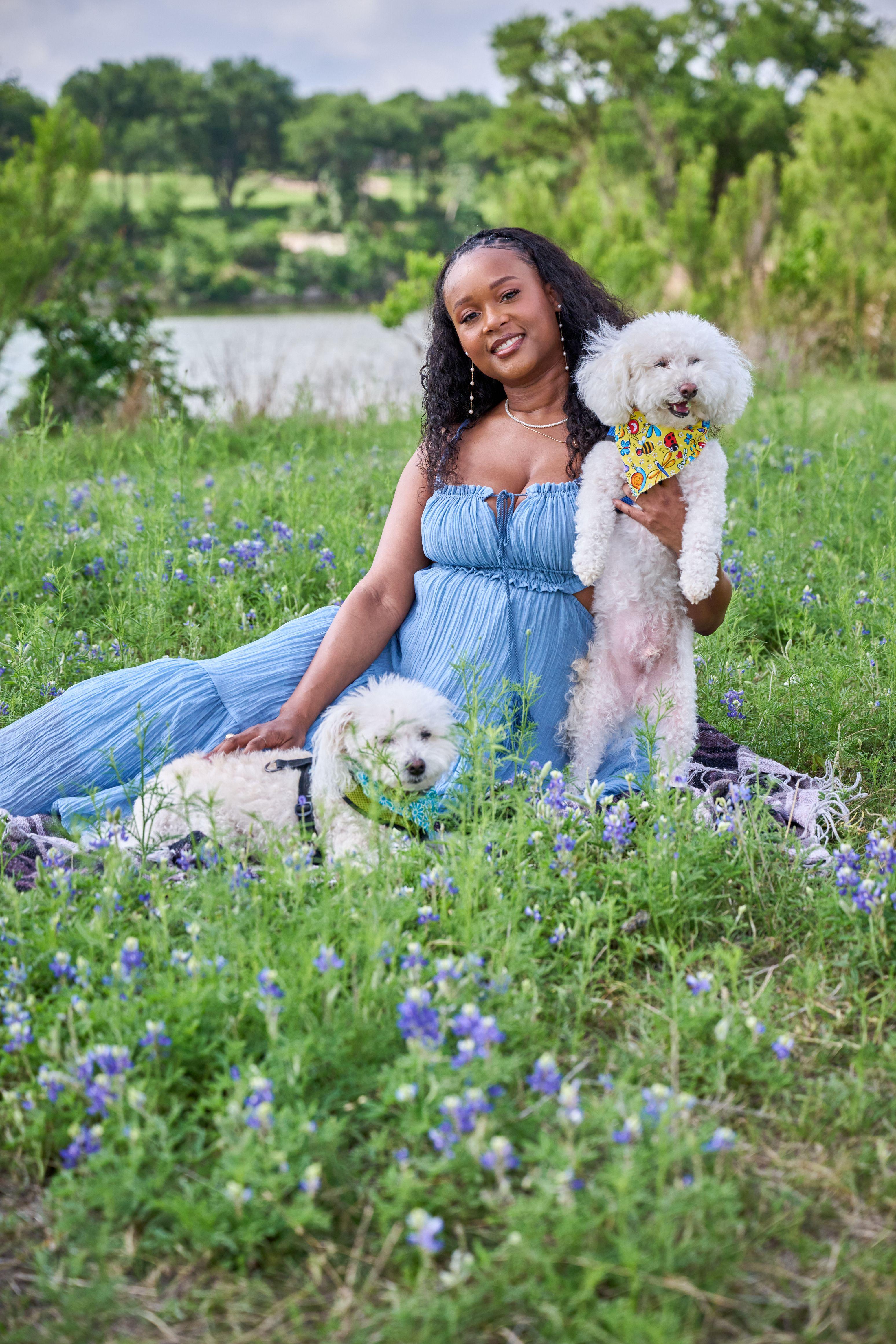Woman in a blue gown seated among bluebonnets with two small white dogs — Seasonal Wildflower Season in Texas photography, Austin A woman in a blue gown seated among bluebonnets with two small white dogs.