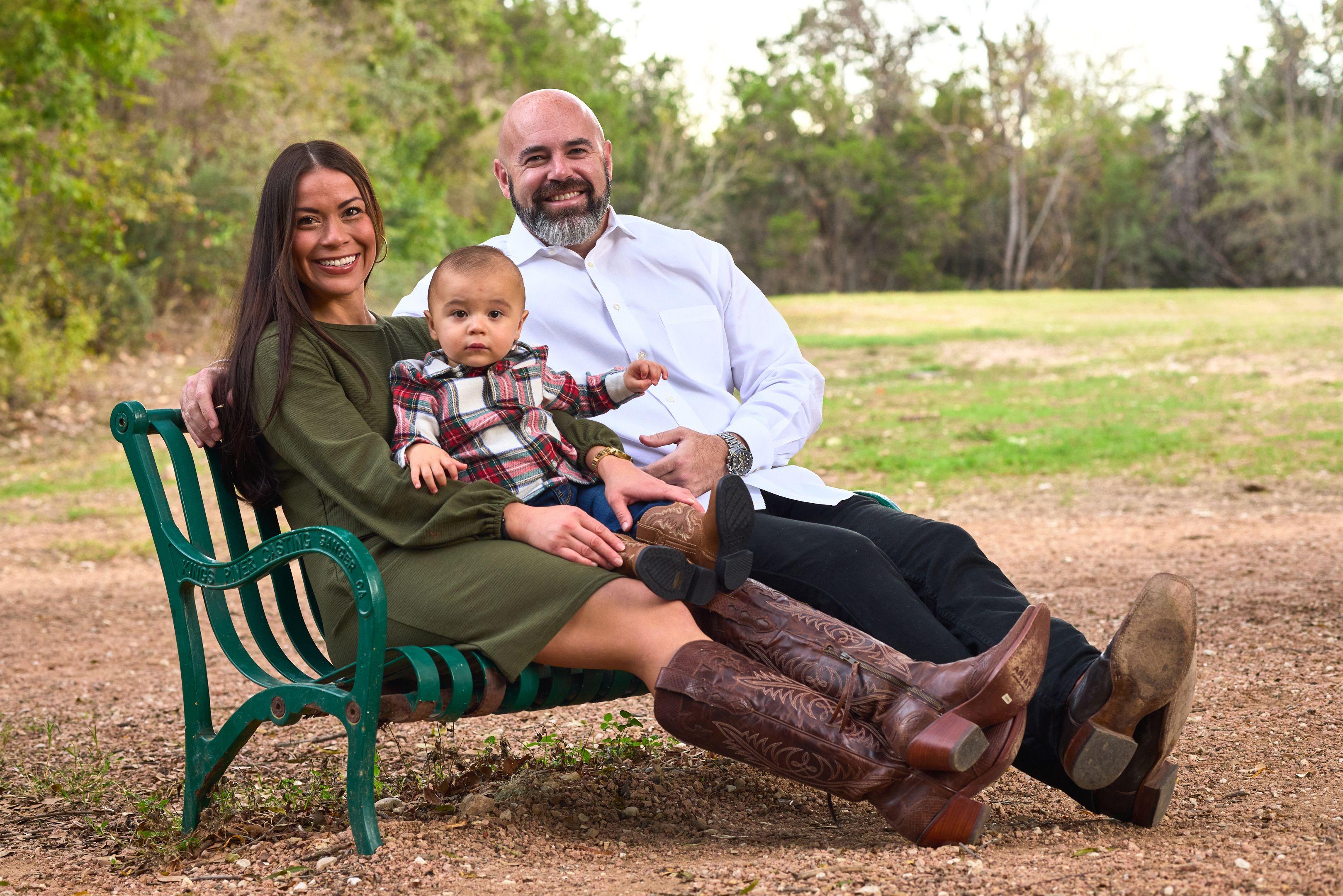 Family sitting together on a log bench in the shade at Red Bud Isle — Red Bud Isle photography, Austin A family sitting together on a log bench in the shade at Red Bud Isle