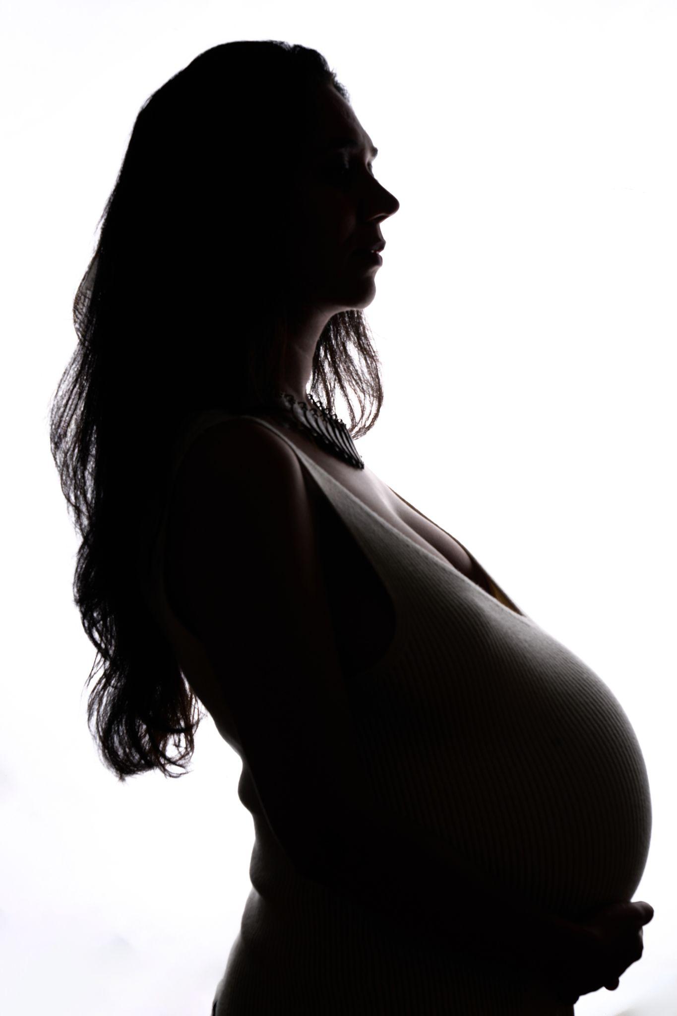 Silhouette of a pregnant woman's profile against a bright background — Maternity photography, Austin Silhouette of a pregnant woman's profile against a bright background