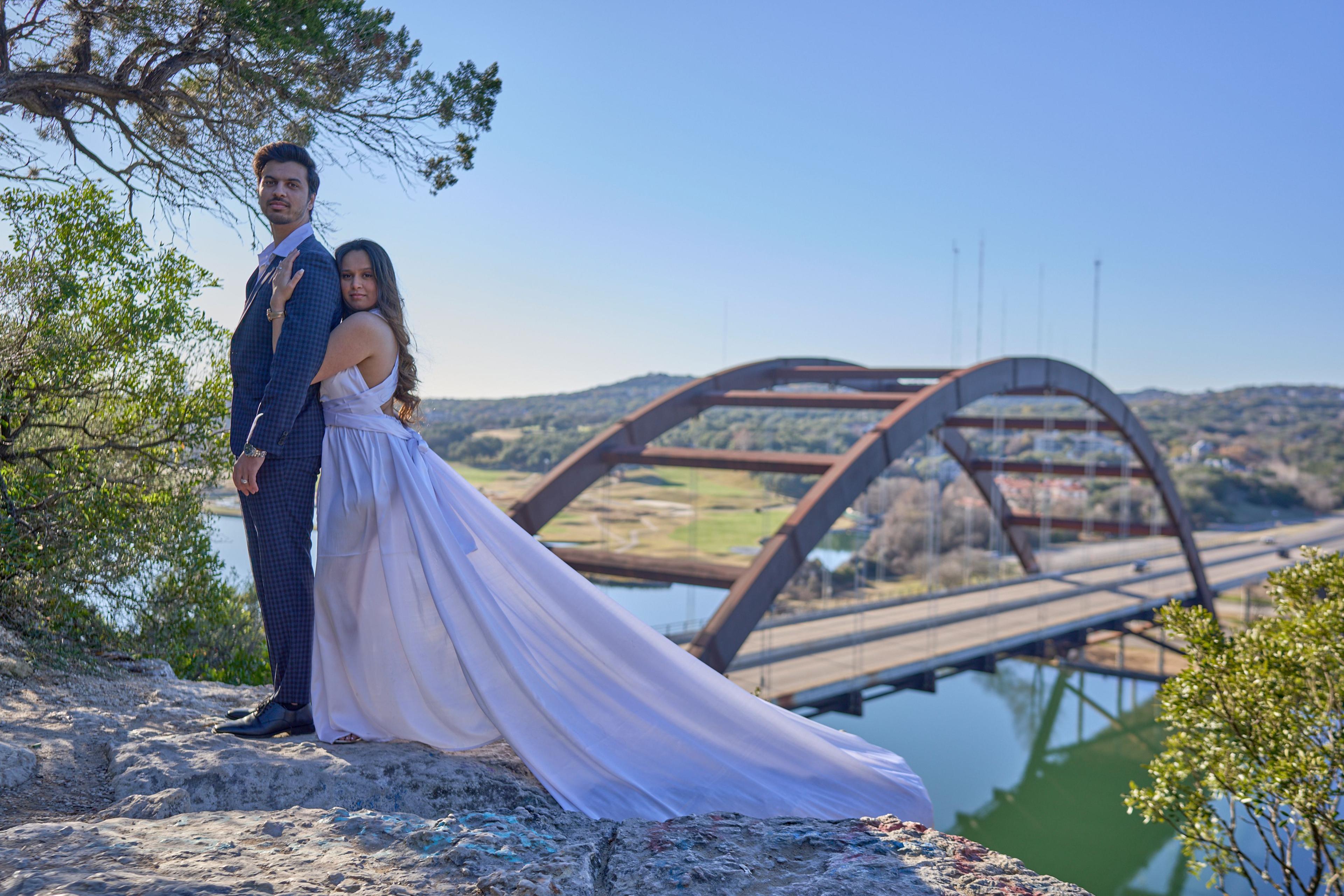 Woman in a lavender dress with a long train standing on the bluff above Lake Austin — Pennybacker Bridge photography, Austin A woman in a lavender dress with a long train standing on the bluff above Lake Austin, the Pennybacker Bridge arch behind her