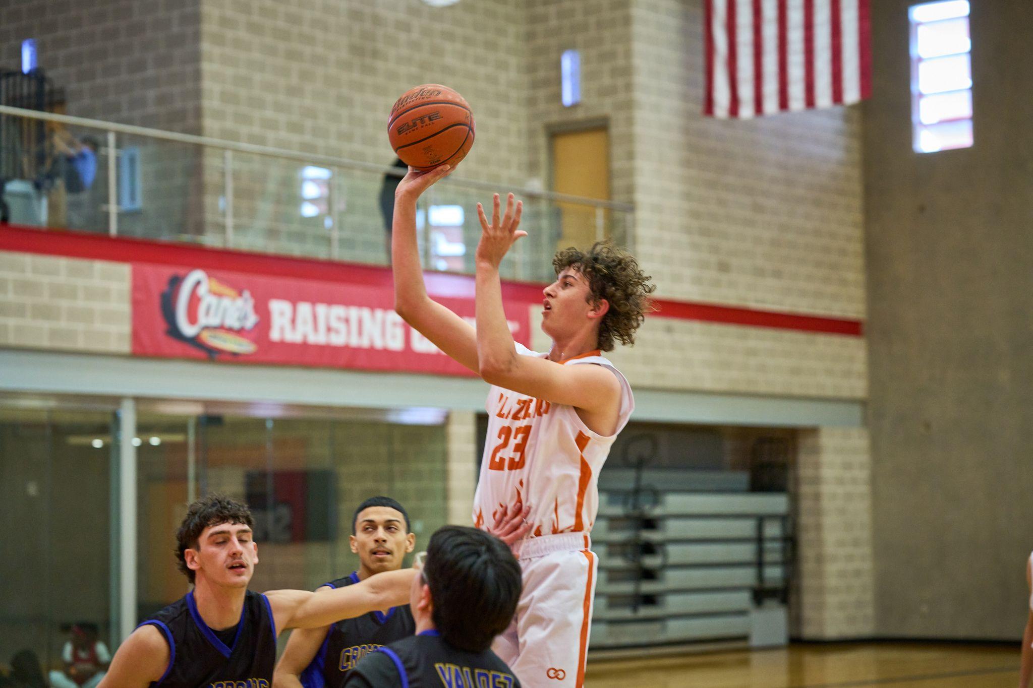 Basketball player rising for a jump shot as defenders contest — Sports photography, Austin Basketball player rising for a jump shot as defenders contest