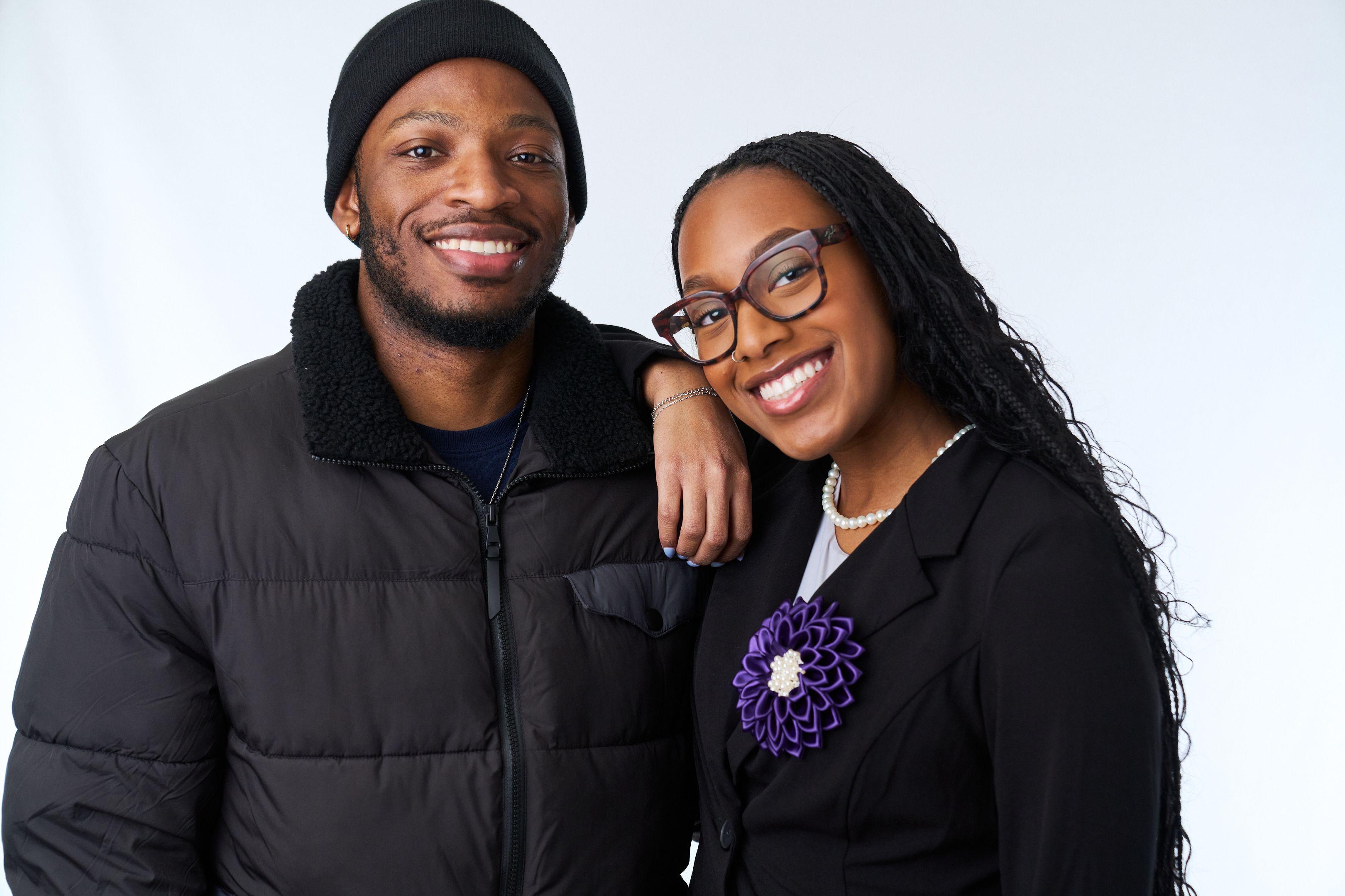 Couple in black outerwear standing close together and smiling on white seamless — Commercial photo studio, Austin Couple in black outerwear standing close together and smiling on white seamless