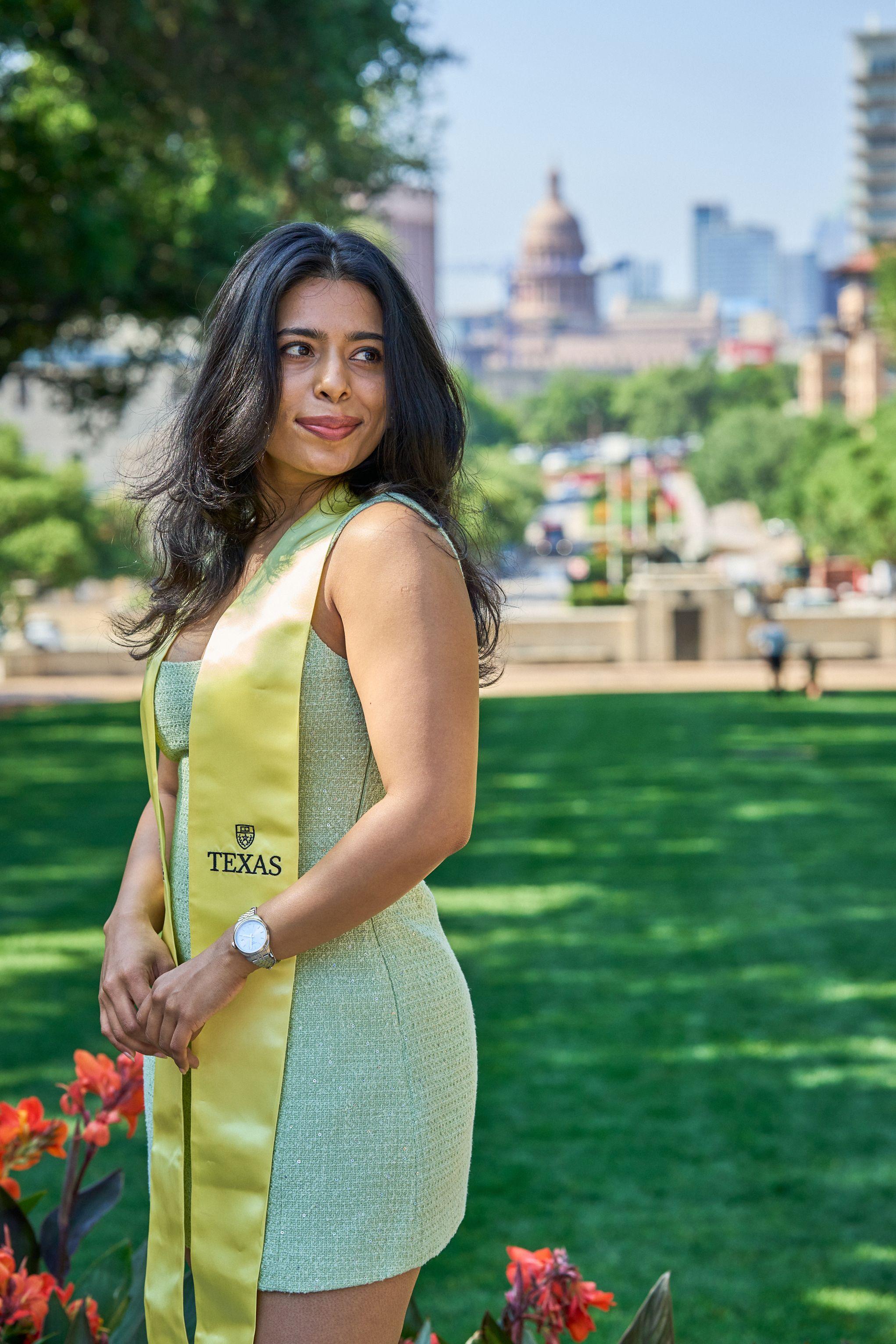 Graduate in a yellow dress and Texas stole on a green lawn, the Capitol — Graduation & Prom photography, Austin A graduate in a yellow dress and Texas stole on a green lawn, the Capitol behind her.