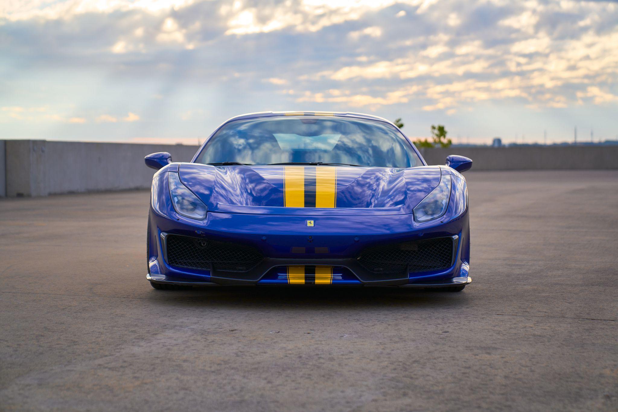 Blue Ferrari with yellow racing stripes photographed head-on at dusk — Automotive photography, Austin A blue Ferrari with yellow racing stripes photographed head-on at dusk.