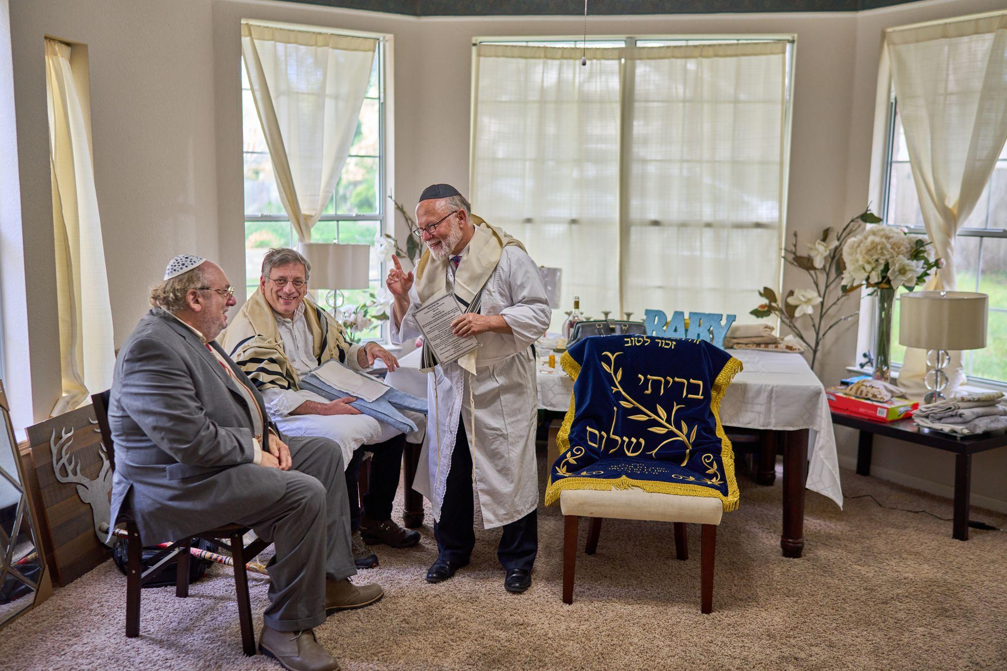 Rabbi in a tallit leading a small service in a bright room, congregants seated — Religious Ceremonies photography, Austin A rabbi in a tallit leading a small service in a bright room, congregants seated.