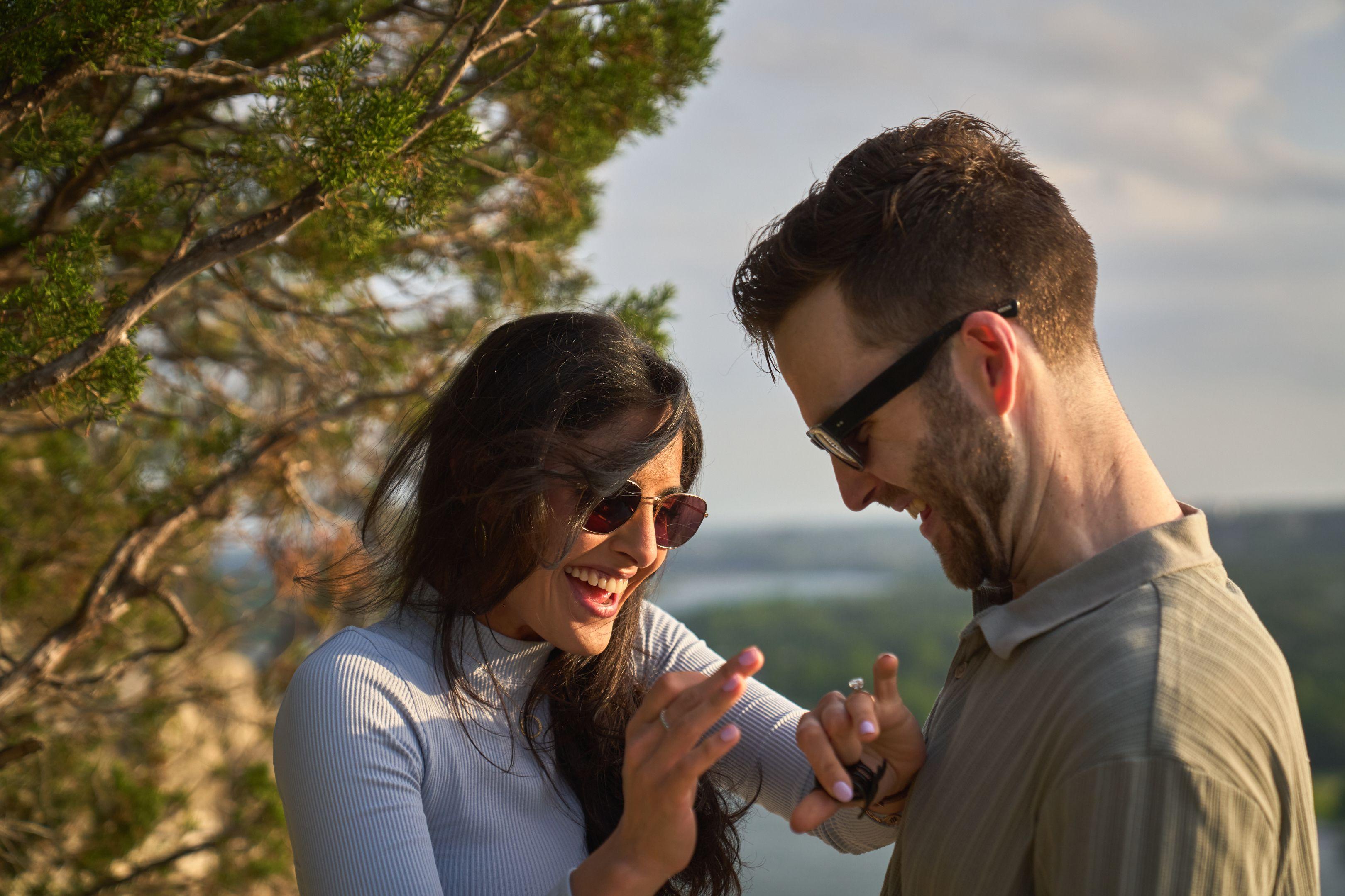 Newly engaged couple laughing as she looks at her ring — Mount Bonnell portraits, Austin Newly engaged couple laughing as she looks at her ring