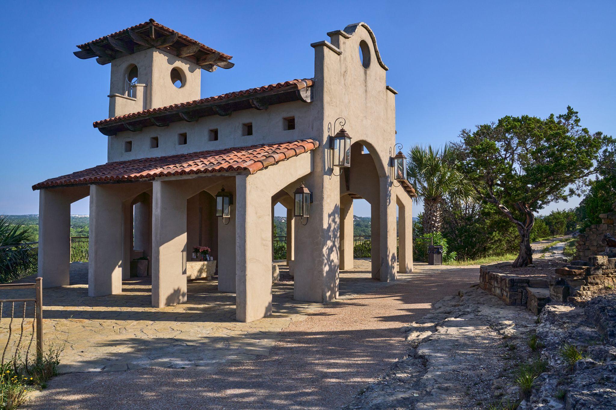Spanish revival building with arched openings, bell tower and tiled roof — Architectural photography, Austin A Spanish revival building with arched openings, bell tower and tiled roof.