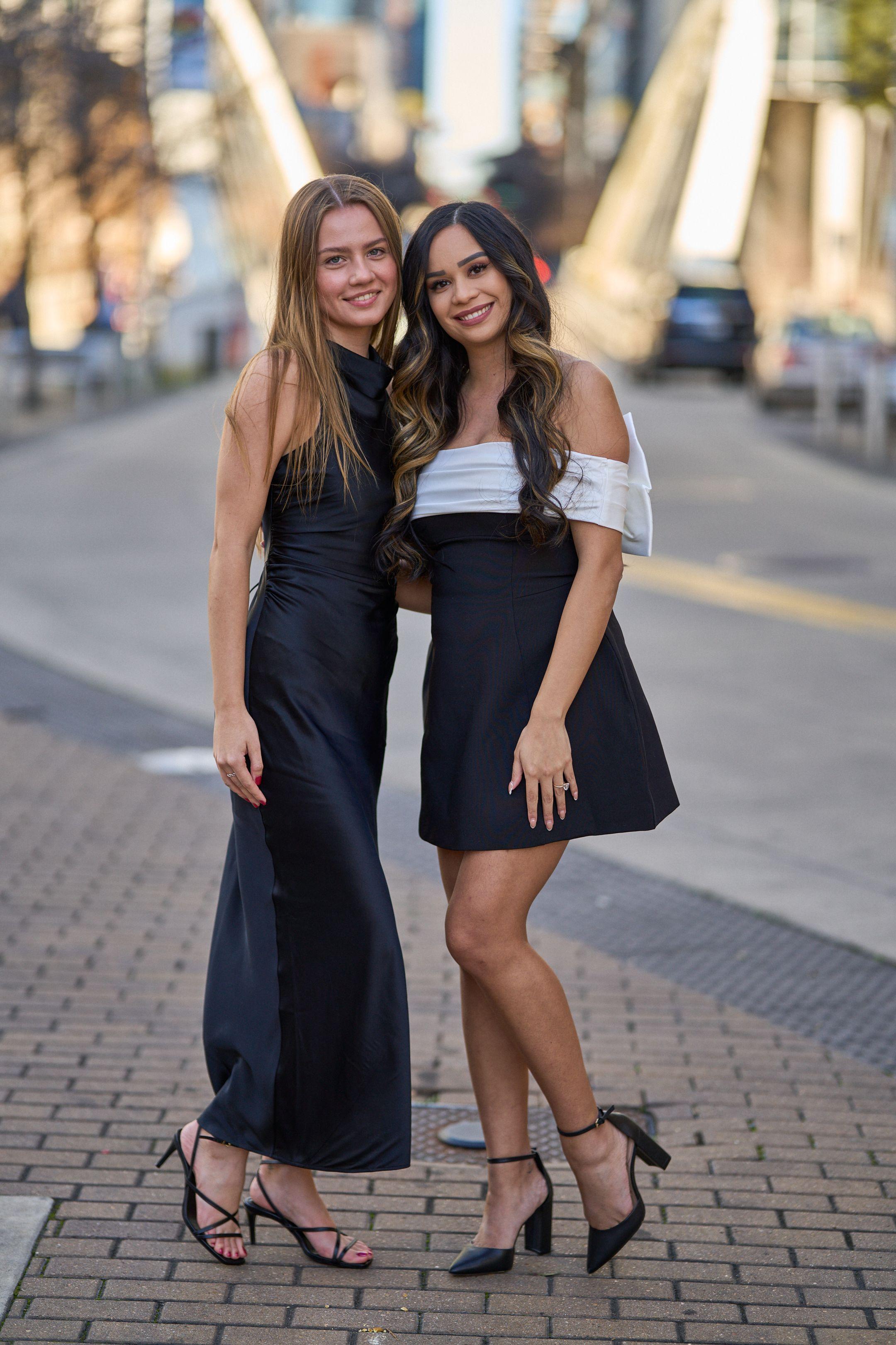 Two friends in black and white outfits posed together on a downtown street — Bachelor & Bachelorette photography, Austin Two friends in black and white outfits posed together on a downtown street.