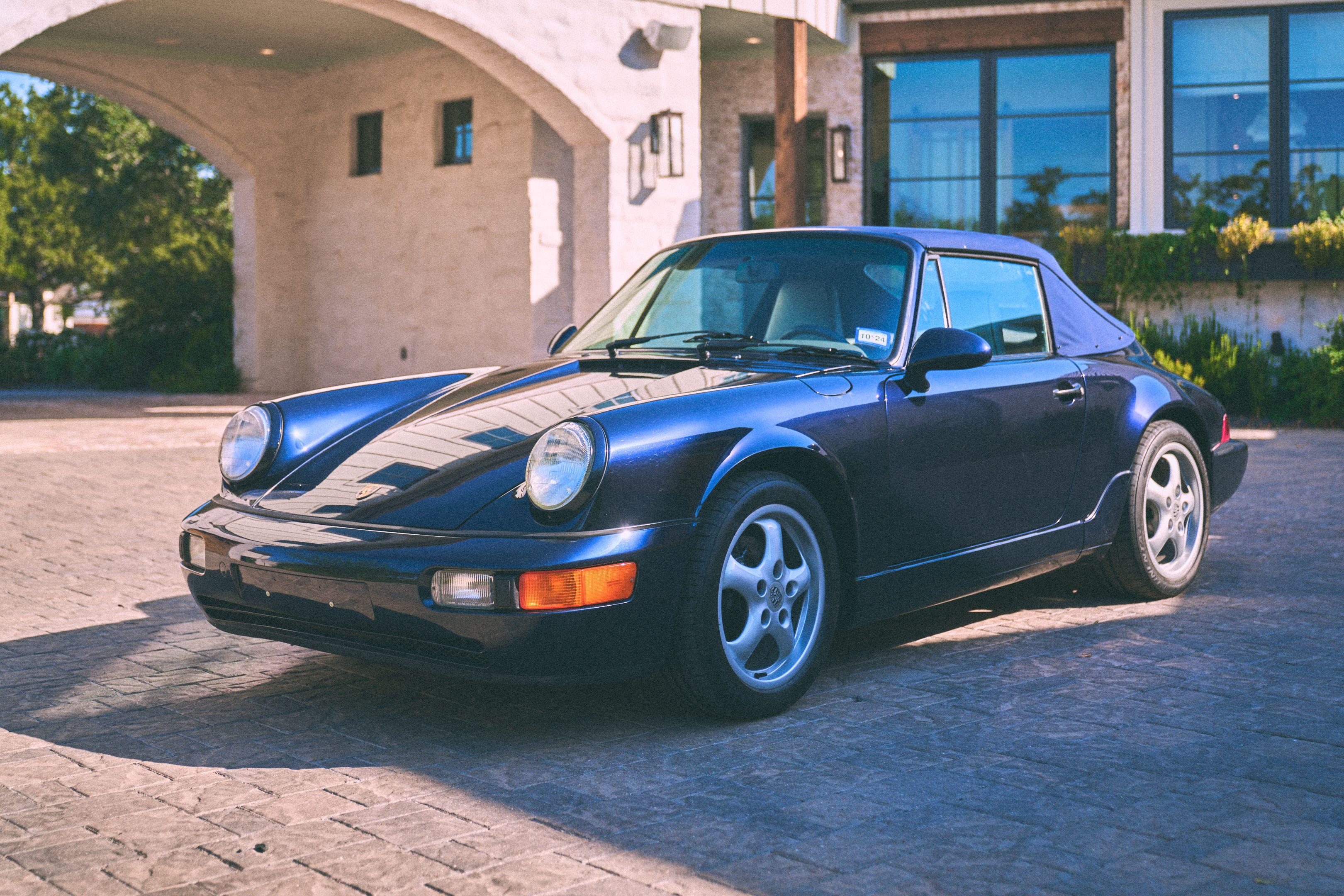 Dark blue classic Porsche 911 parked beside a stone building in warm film-toned light — Film & vintage photography, Austin Film Vintage & Vibey Photography