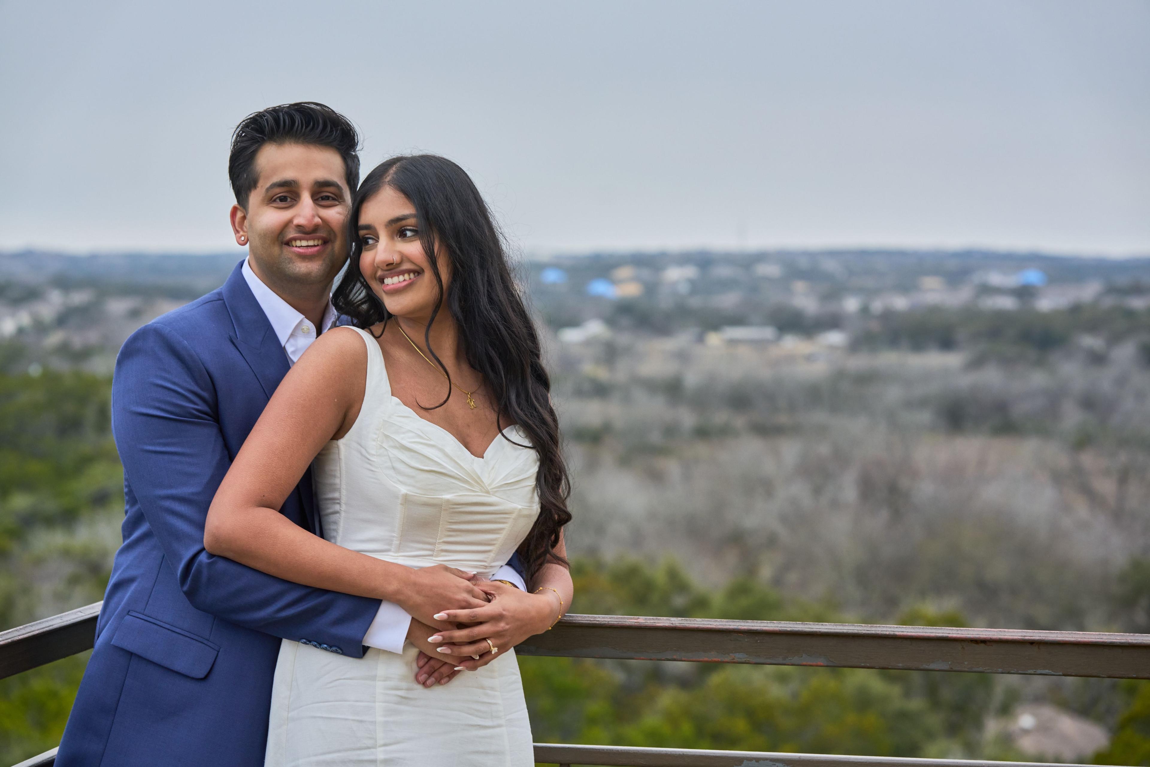 Couple standing at the bluff rail below Chapel Dulcinea, open hill country beyond — Chapel Dulcinea photography, Austin A couple standing at the bluff rail below Chapel Dulcinea, open hill country beyond