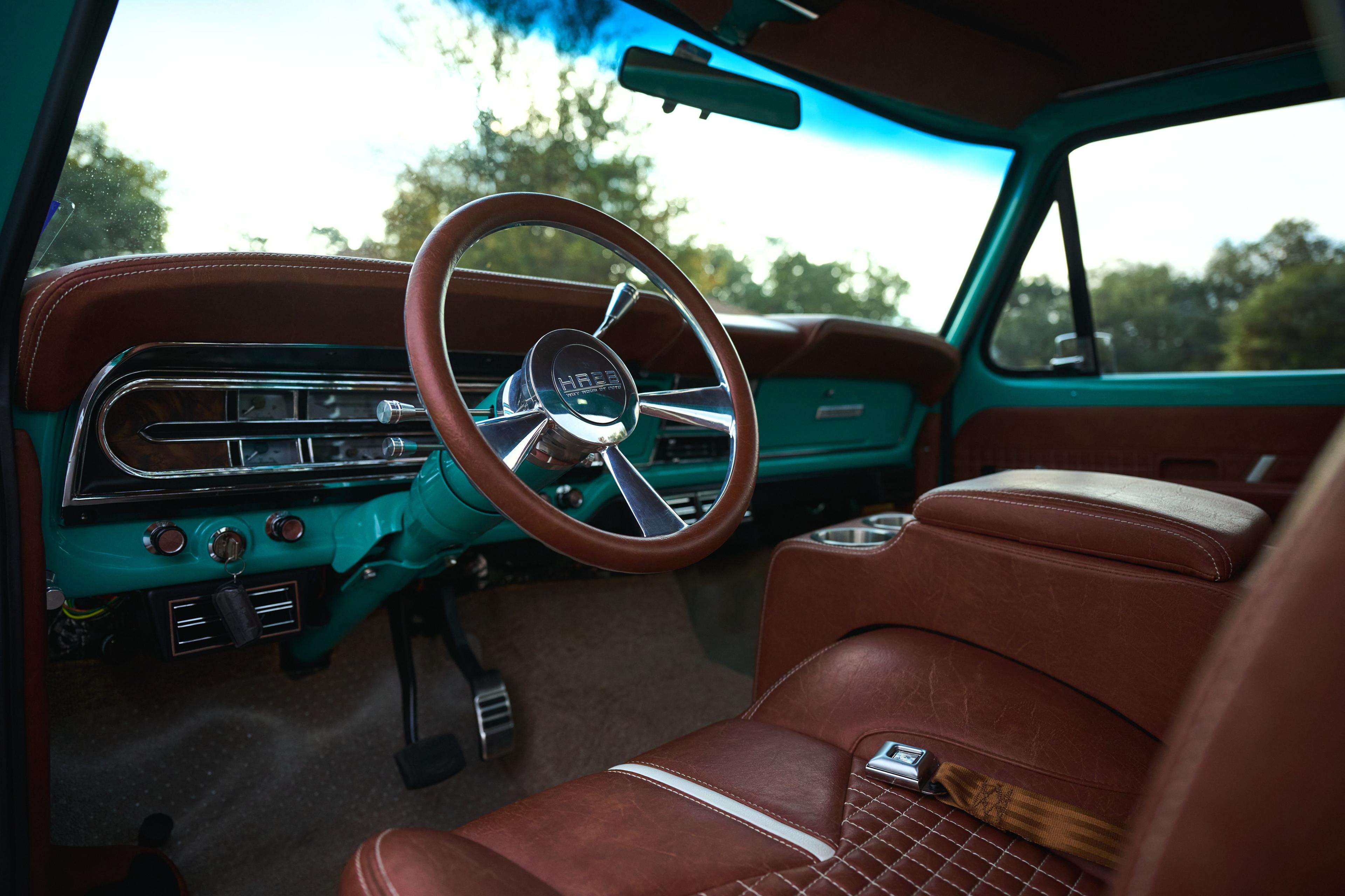 Brown leather interior and chrome steering wheel of a restored teal pickup — Automotive photography, Austin The brown leather interior and chrome steering wheel of a restored teal pickup.
