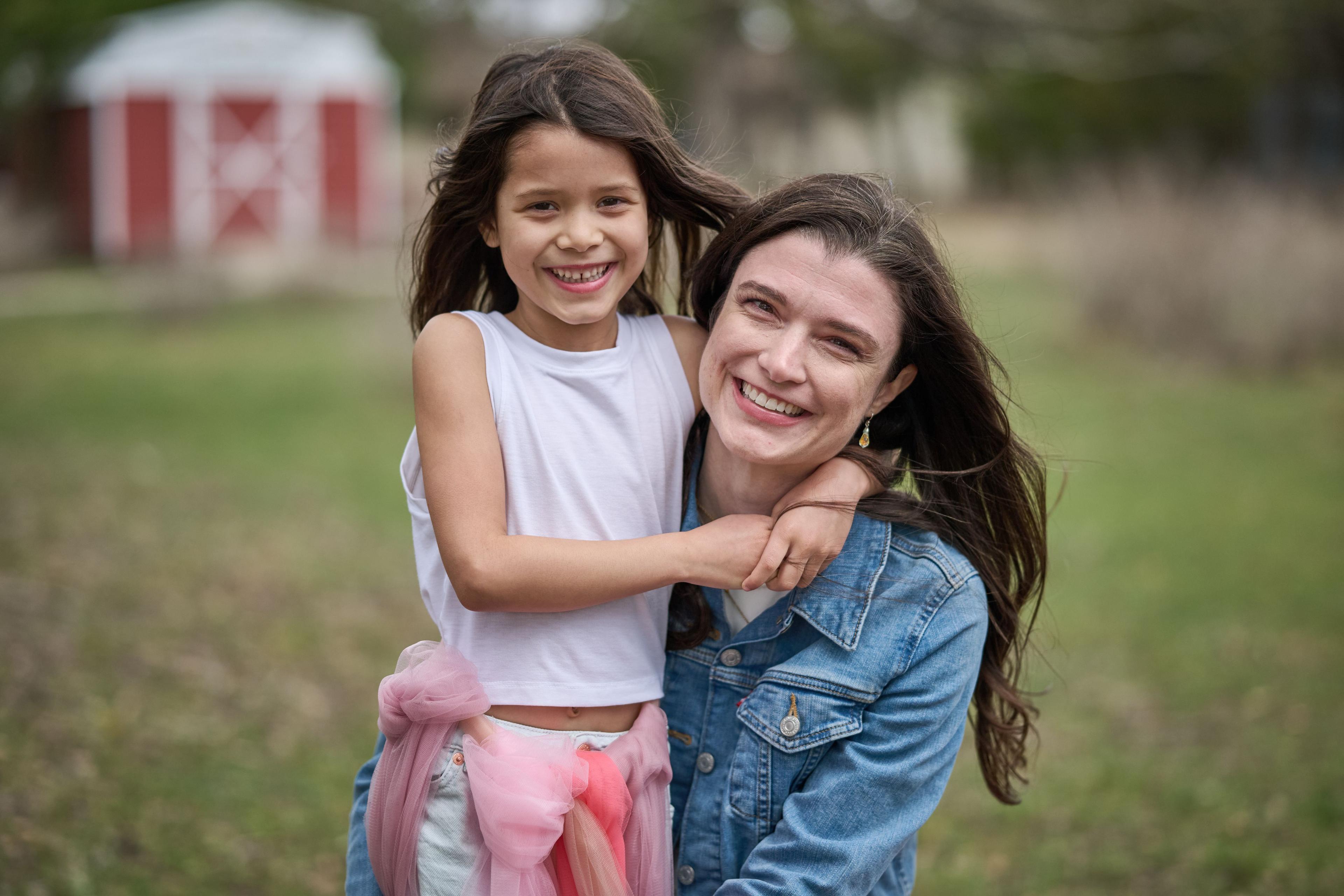 Family of women in denim and pink gathered together on the ground at Wimberley — Wimberley TX photography, Austin A family of women in denim and pink gathered together on the ground at Wimberley