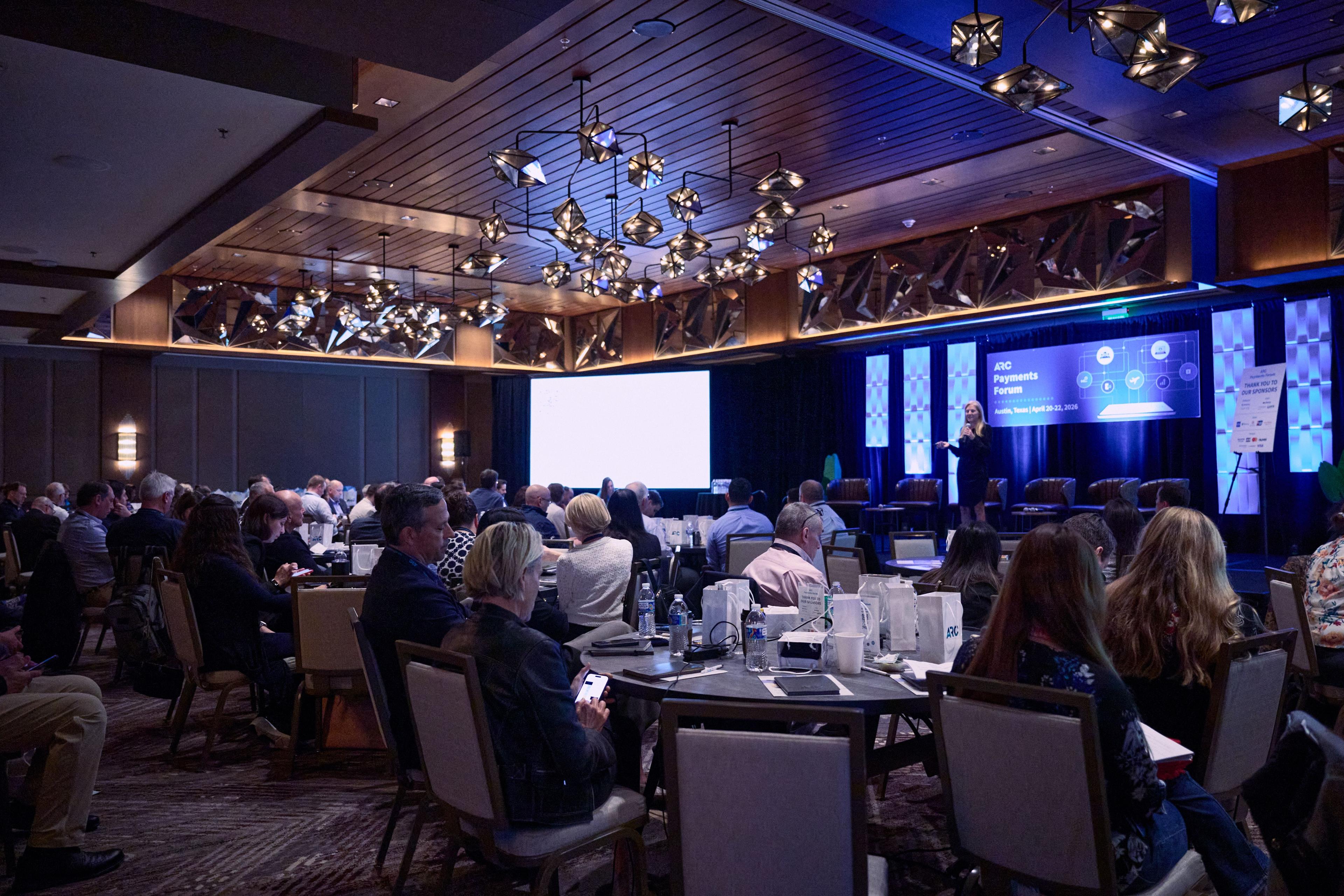 Conference delegates seated at round tables under sculptural pendant lights — Conventions & Tradeshows photography, Austin Conference delegates seated at round tables under sculptural pendant lights.