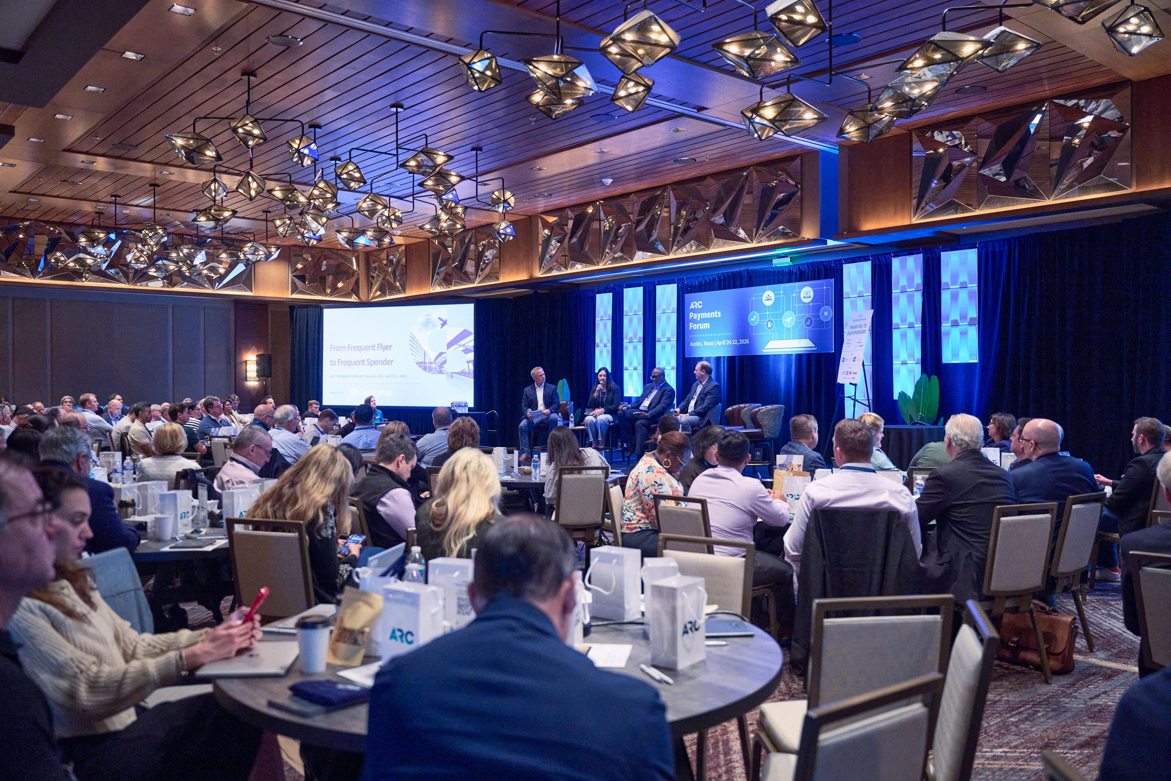 Wide view across a busy conference ballroom mid-session, screens lit blue — Conventions & Tradeshows photography, Austin A wide view across a busy conference ballroom mid-session, screens lit blue.