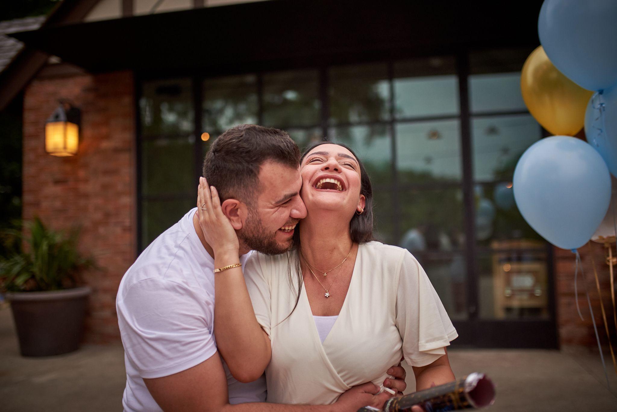 Couple laughing together in front of the glass and stone pavilion — Pease Park photography, Austin A couple laughing together in front of the glass and stone pavilion at the south end of Pease Park