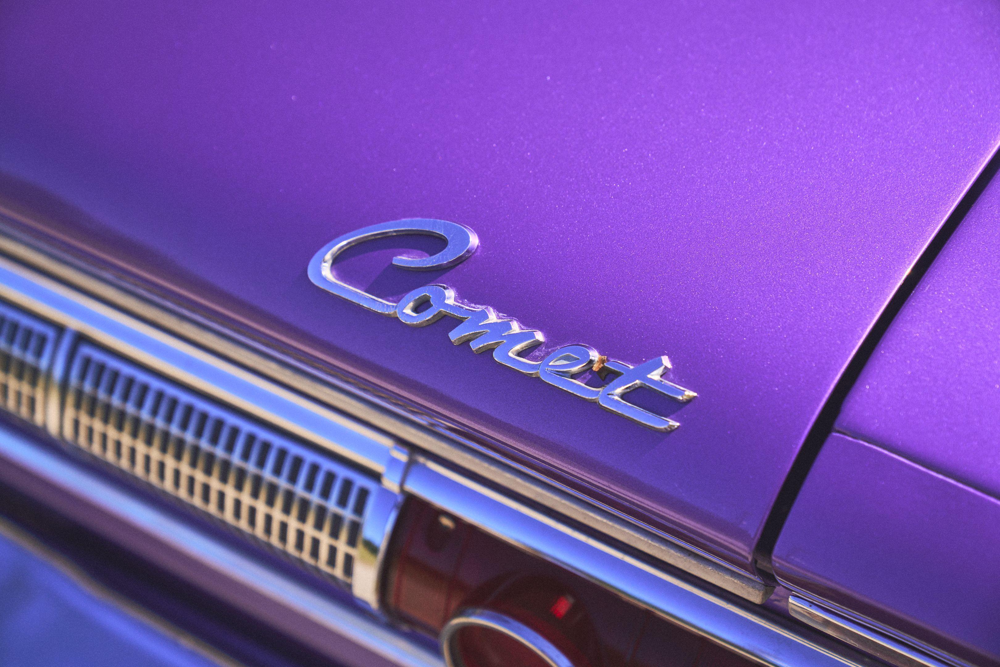 Close film-toned detail of a chrome Comet script badge on a purple car — Film & vintage photography, Austin A close film-toned detail of a chrome Comet script badge on a purple car.