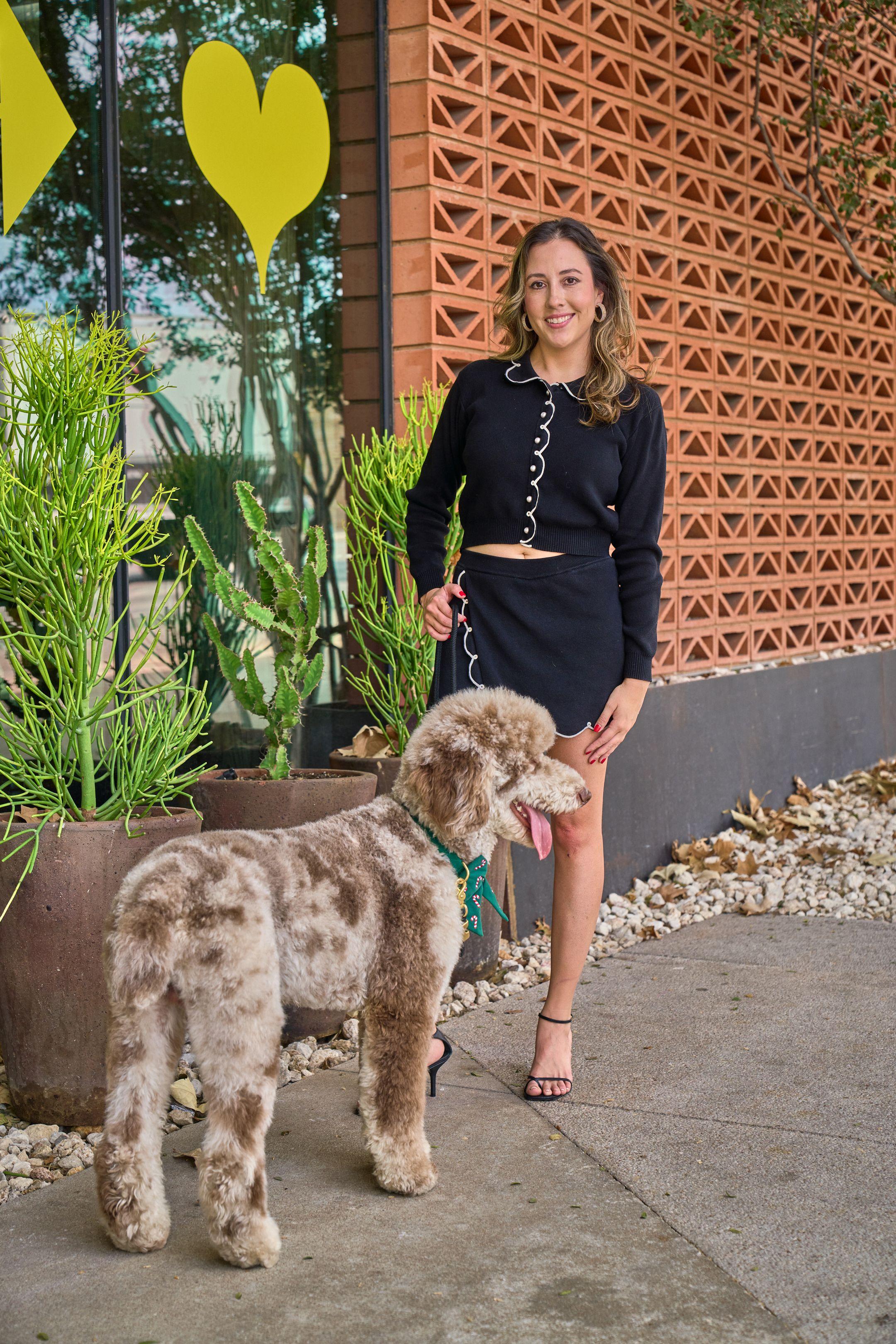 Woman walking her labradoodle past patterned brickwork and desert planting — South Congress (SoCo) photography, Austin A woman walking her labradoodle past patterned brickwork and desert planting.