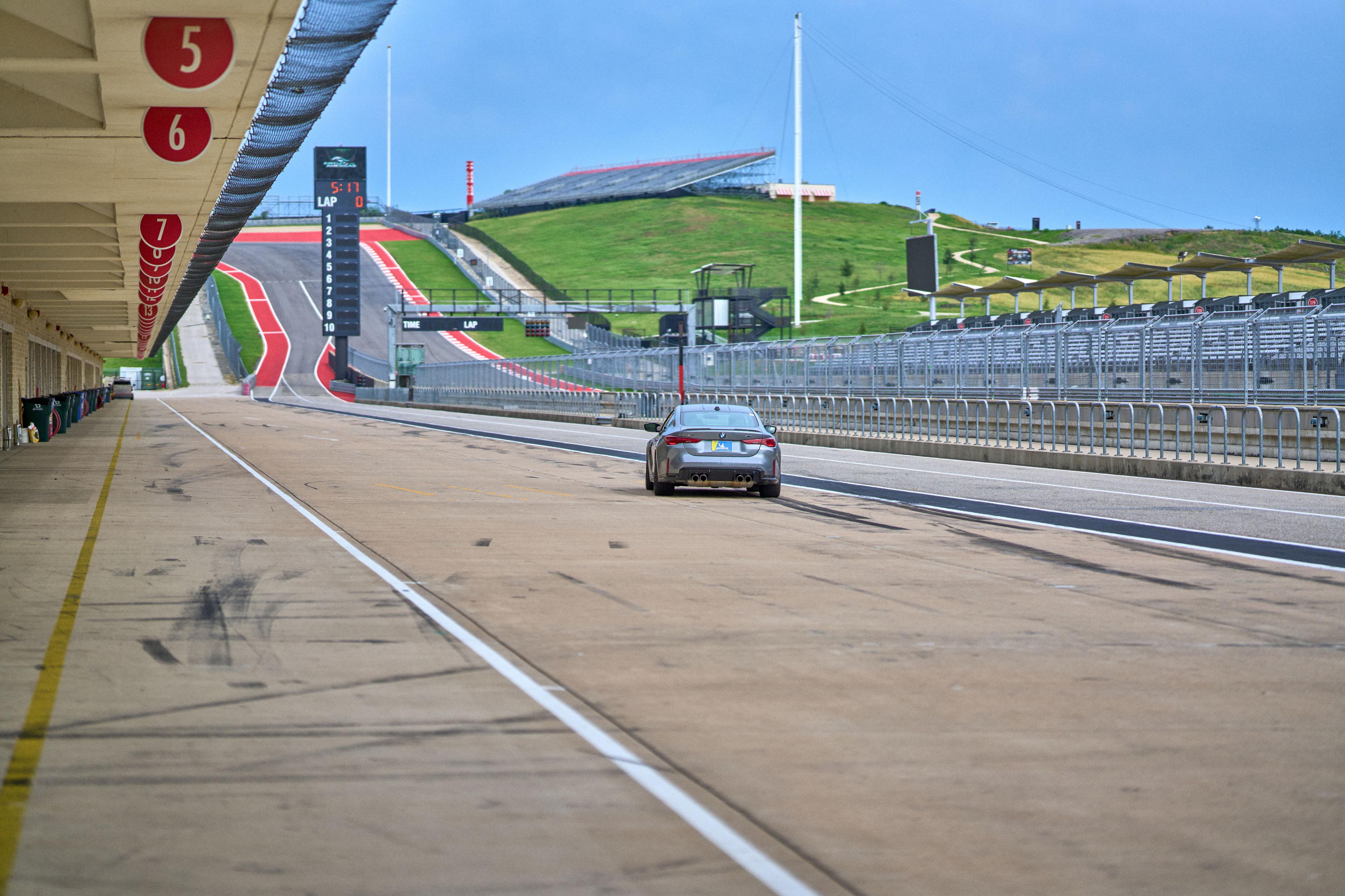 Car accelerating up the track at Circuit of the Americas — Adventure & outdoor photography, Austin A car accelerating up the track at Circuit of the Americas.