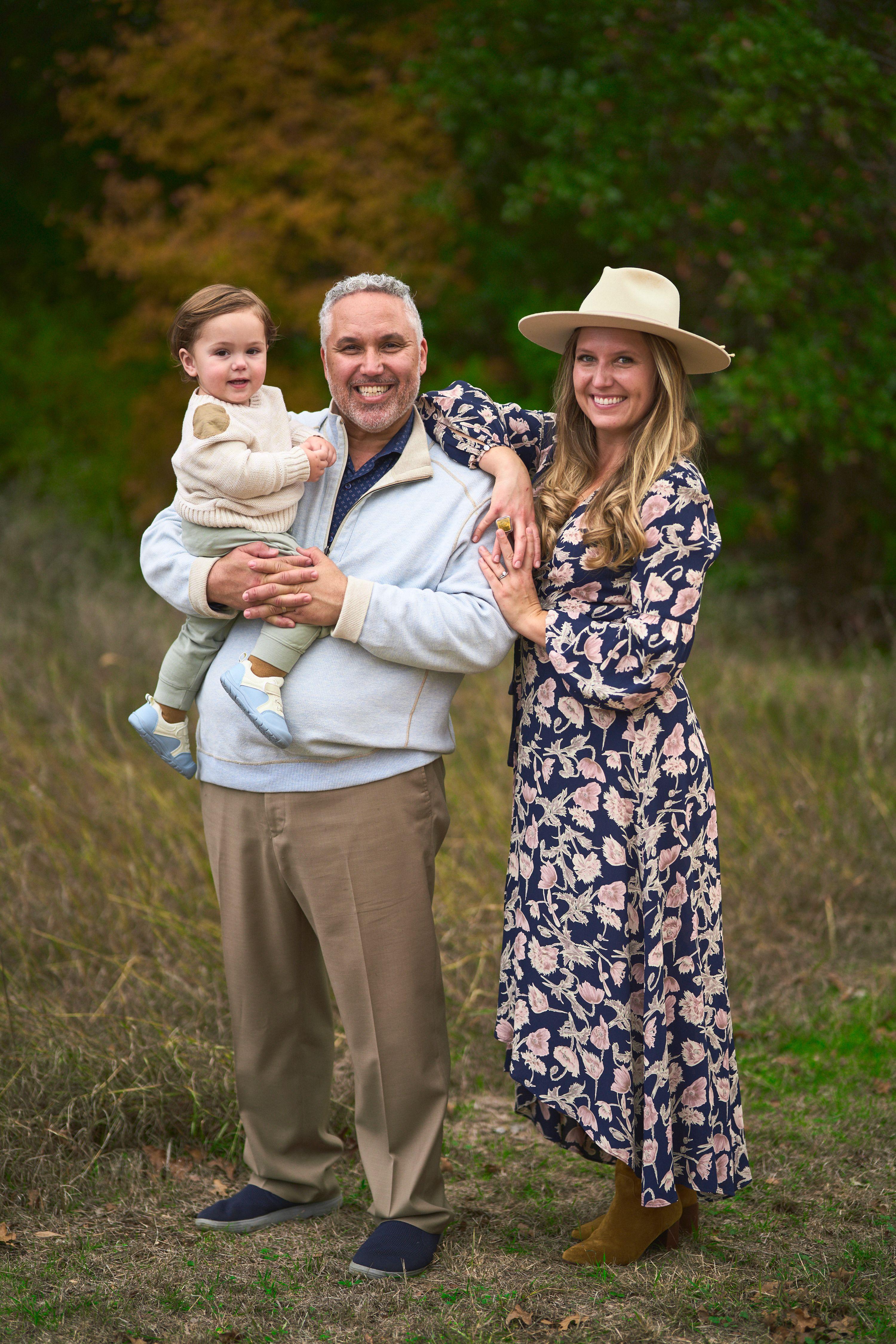 Mother in a straw hat holding her laughing toddler at Circle C Ranch — Circle C Ranch photography, Austin A mother in a straw hat holding her laughing toddler at Circle C Ranch
