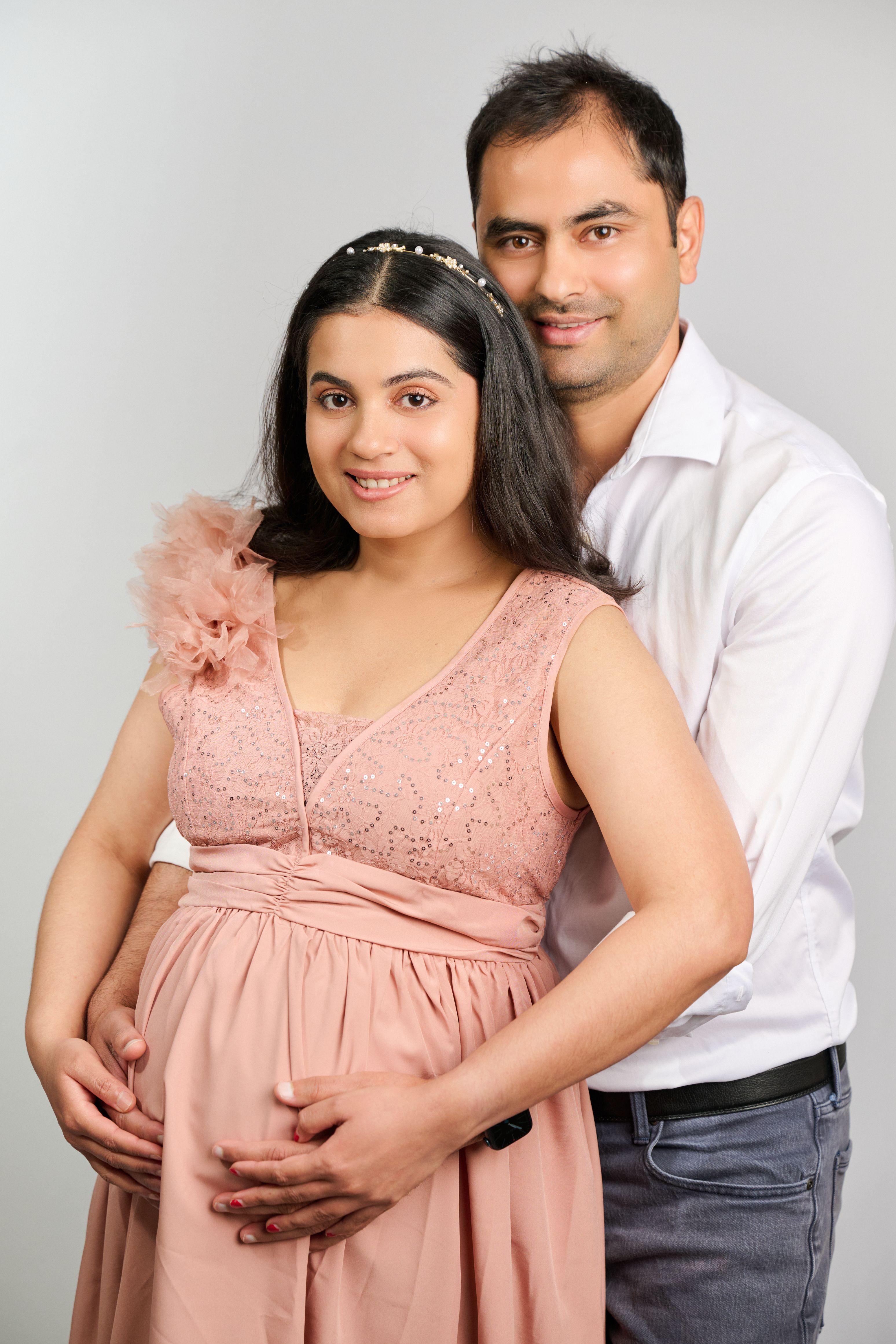Expectant couple in studio, mother in a peach dress — Maternity photography, Austin Expectant couple in studio, mother in a peach dress