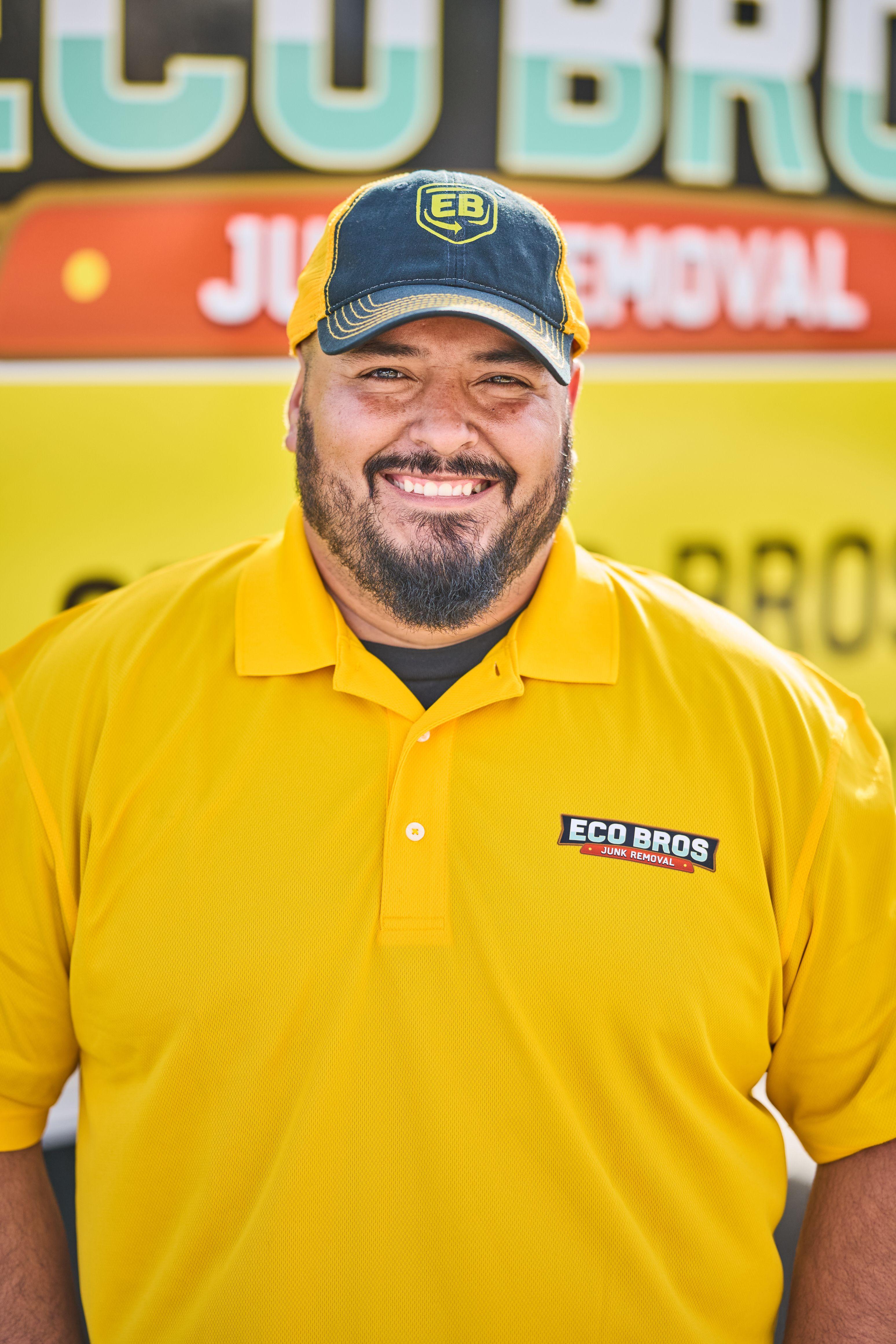 Smiling Eco Bros crew member in a yellow polo and cap in front of a branded truck — Industrial photography, Austin Smiling Eco Bros crew member in a yellow polo and cap in front of a branded truck