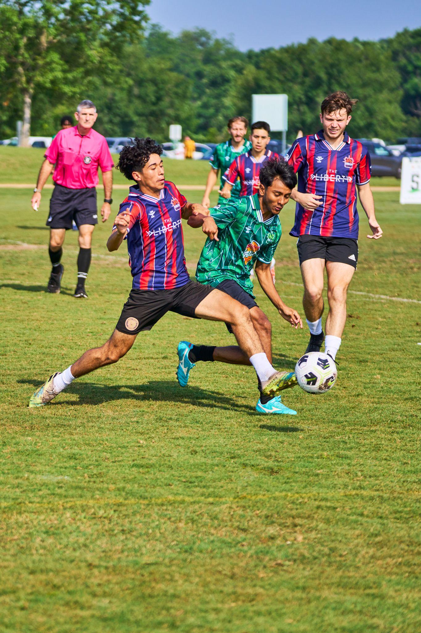 Several adult league players converging on the ball, one stretching in to win it — Sports photography, Austin Several adult league players converging on the ball, one stretching in to win it