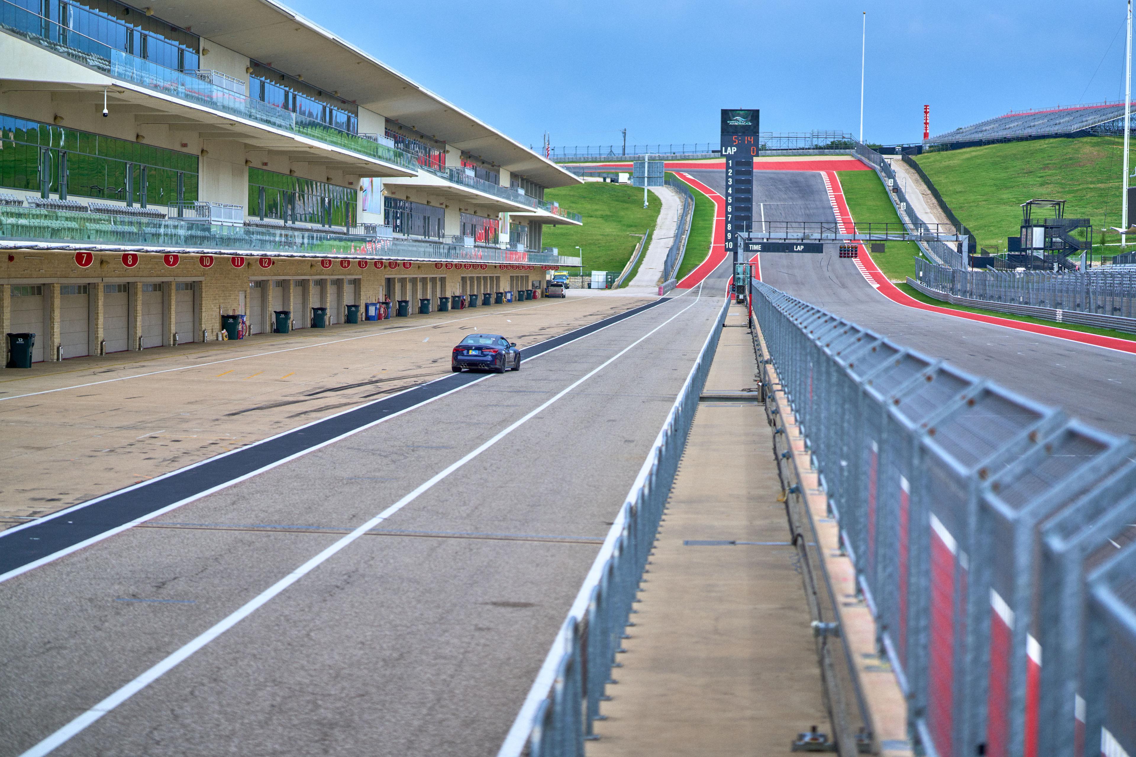 Empty pit lane and race straight at Circuit of the Americas in the morning — Adventure & outdoor photography, Austin An empty pit lane and race straight at Circuit of the Americas in the morning.