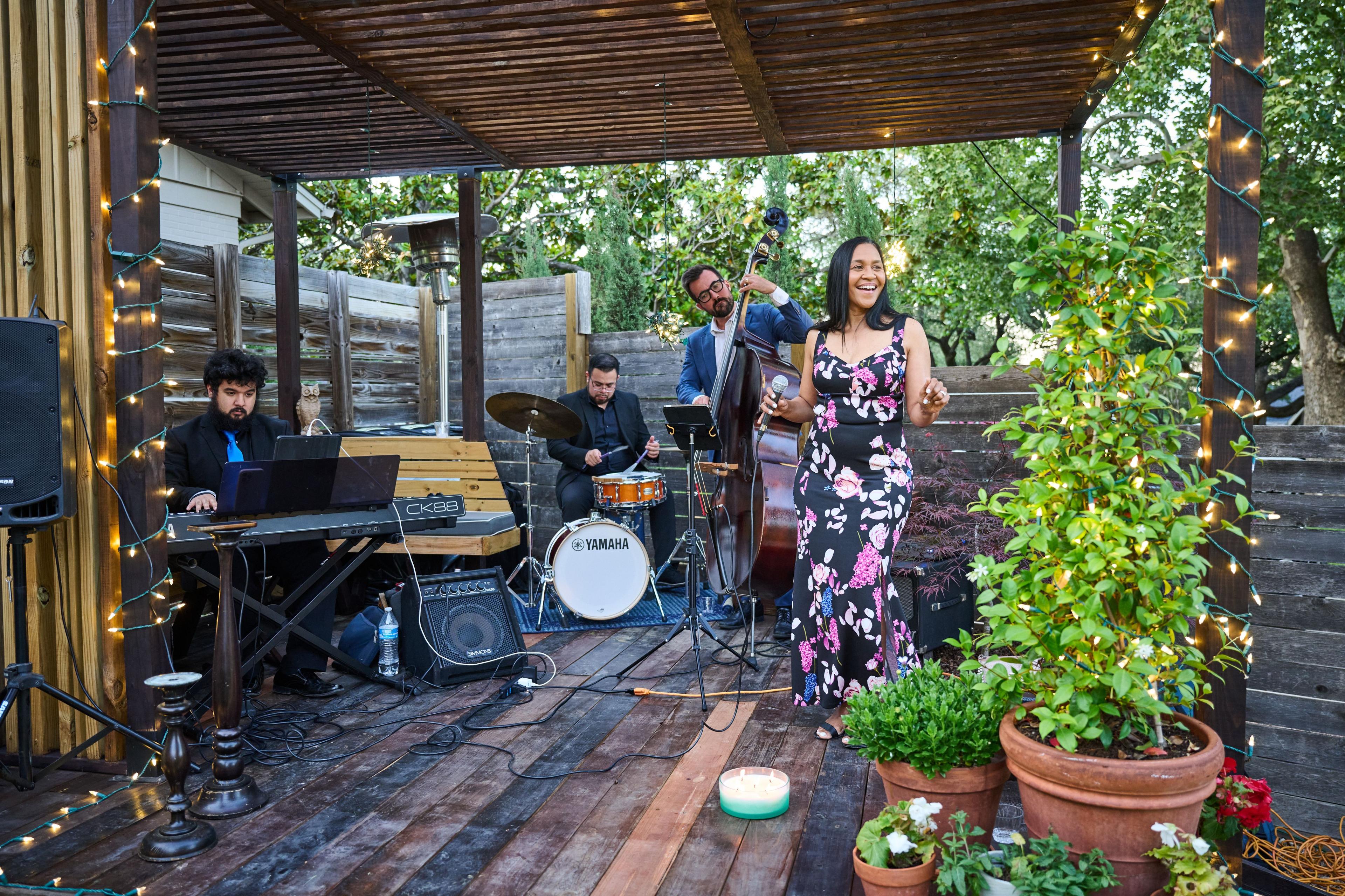 Jazz trio playing on a covered deck at a garden party, the singer in a floral dress — Formal Celebrations photography, Austin A jazz trio playing on a covered deck at a garden party, the singer in a floral dress.