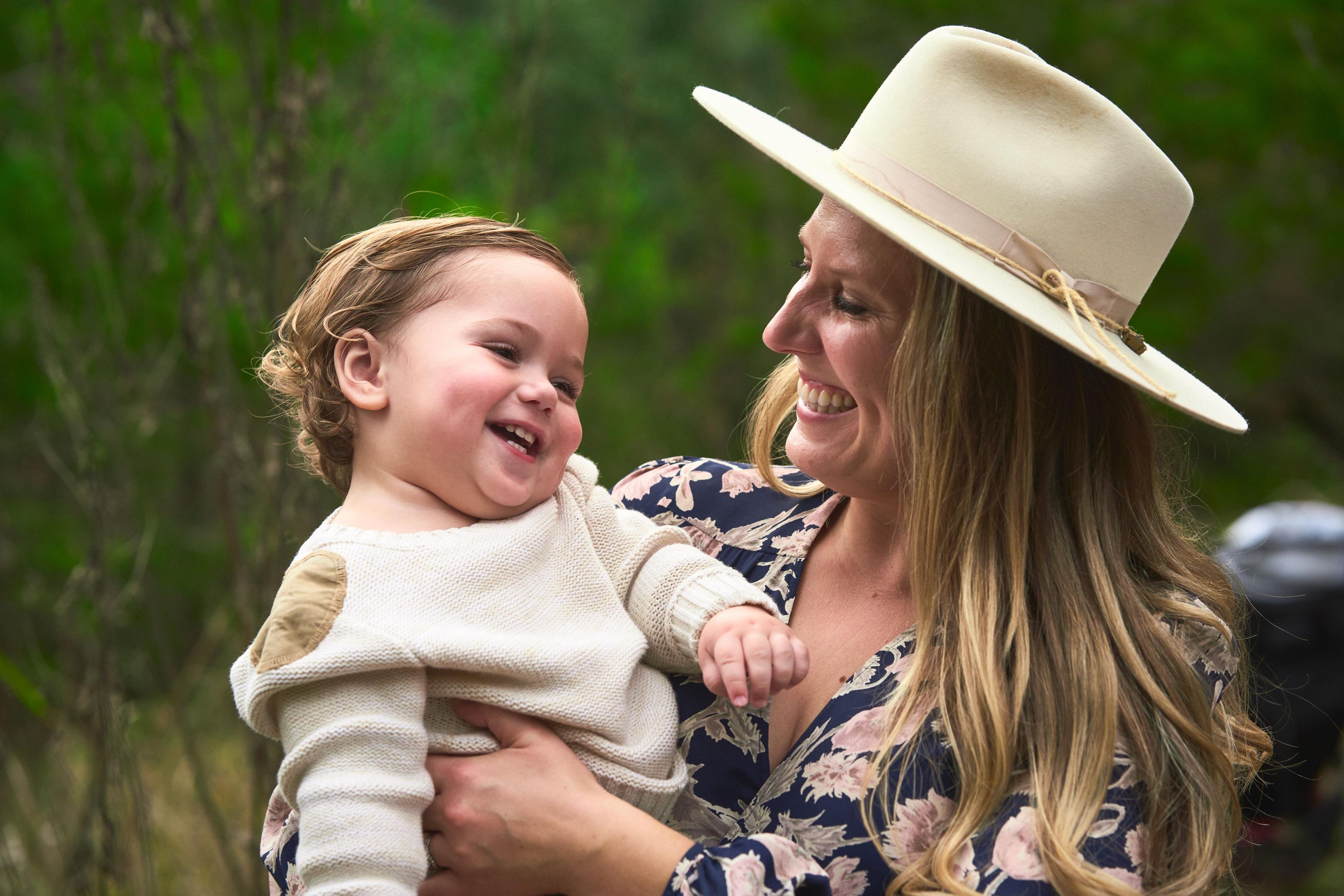 Parents holding their toddler between them in an oak meadow at Circle C Ranch — Circle C Ranch photography, Austin Parents holding their toddler between them in an oak meadow at Circle C Ranch