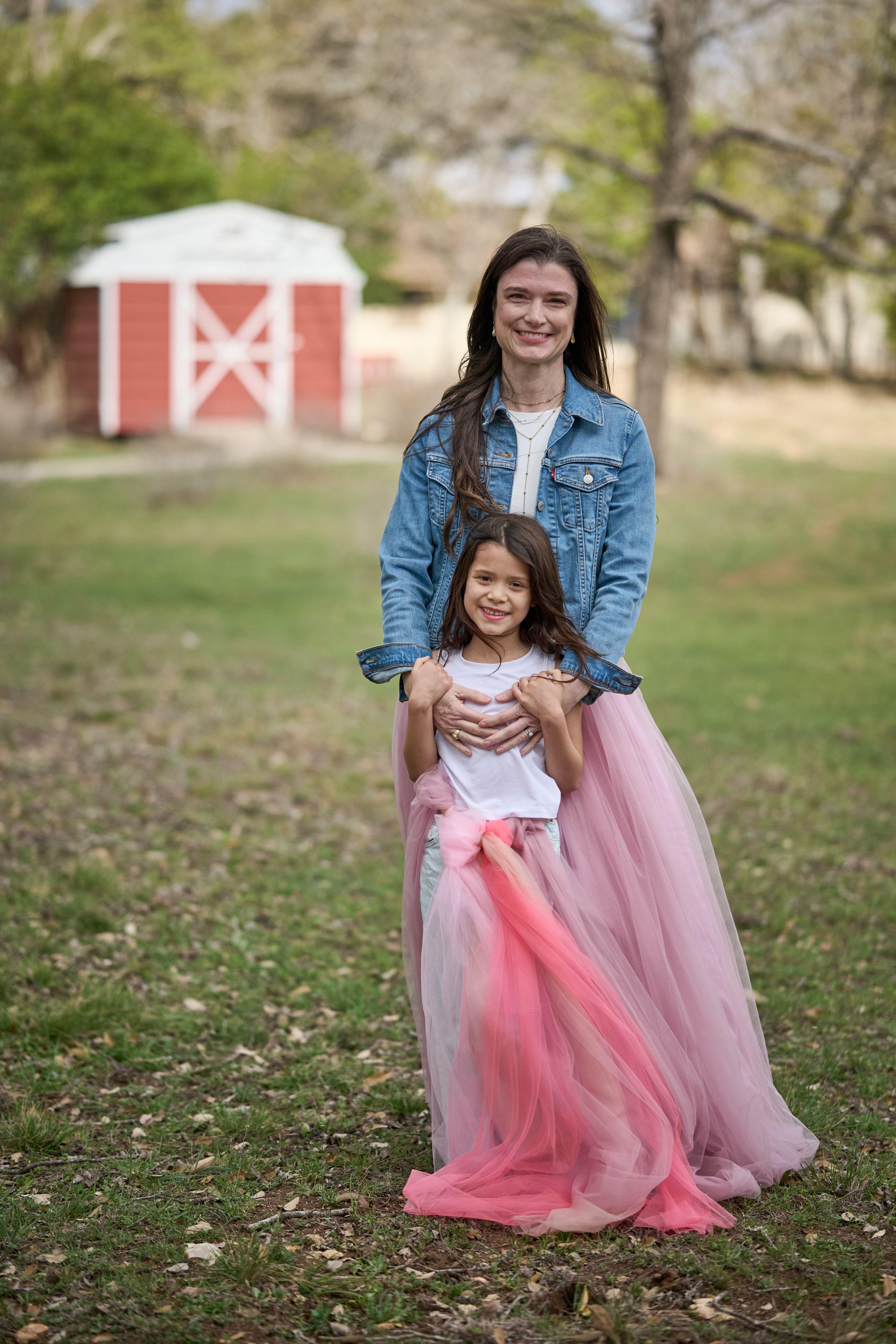 Girl in a white top hugging her mother in a denim jacket at Wimberley — Wimberley TX photography, Austin A girl in a white top hugging her mother in a denim jacket at Wimberley