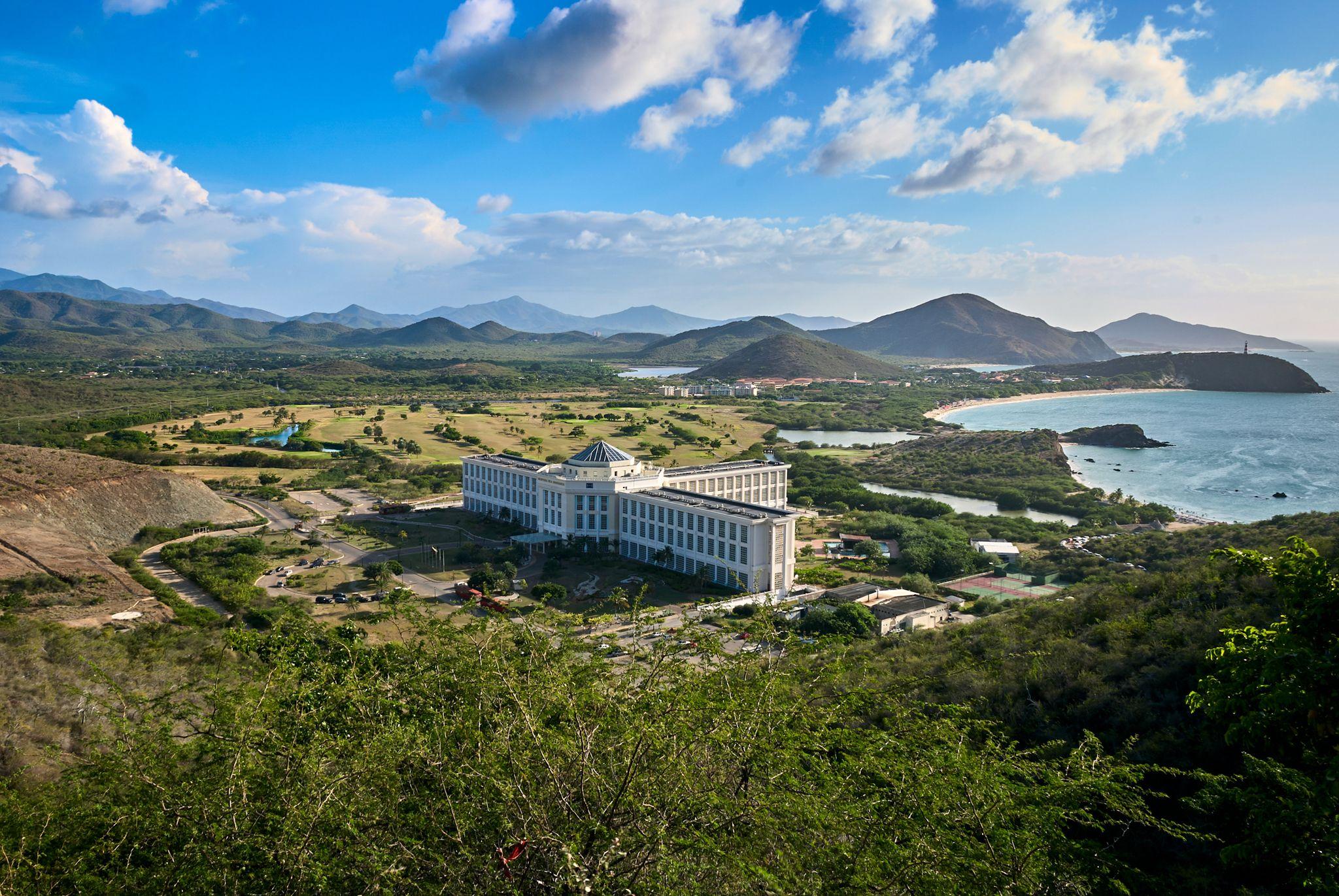 Aerial view of a coastal resort with hills and a bay — Aerial & drone photography, Austin Aerial view of a coastal resort with hills and a bay