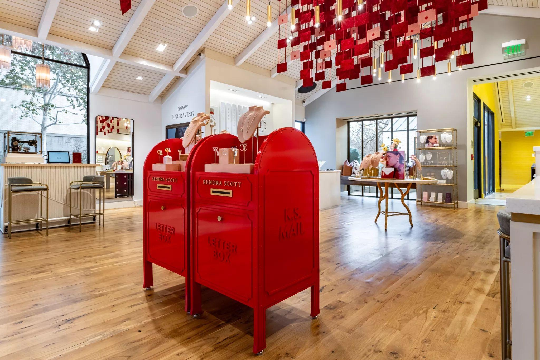 Jewelry store interior with red mailbox displays and a red fabric feature wall — Architectural photography, Austin A jewelry store interior with red mailbox displays and a red fabric feature wall.