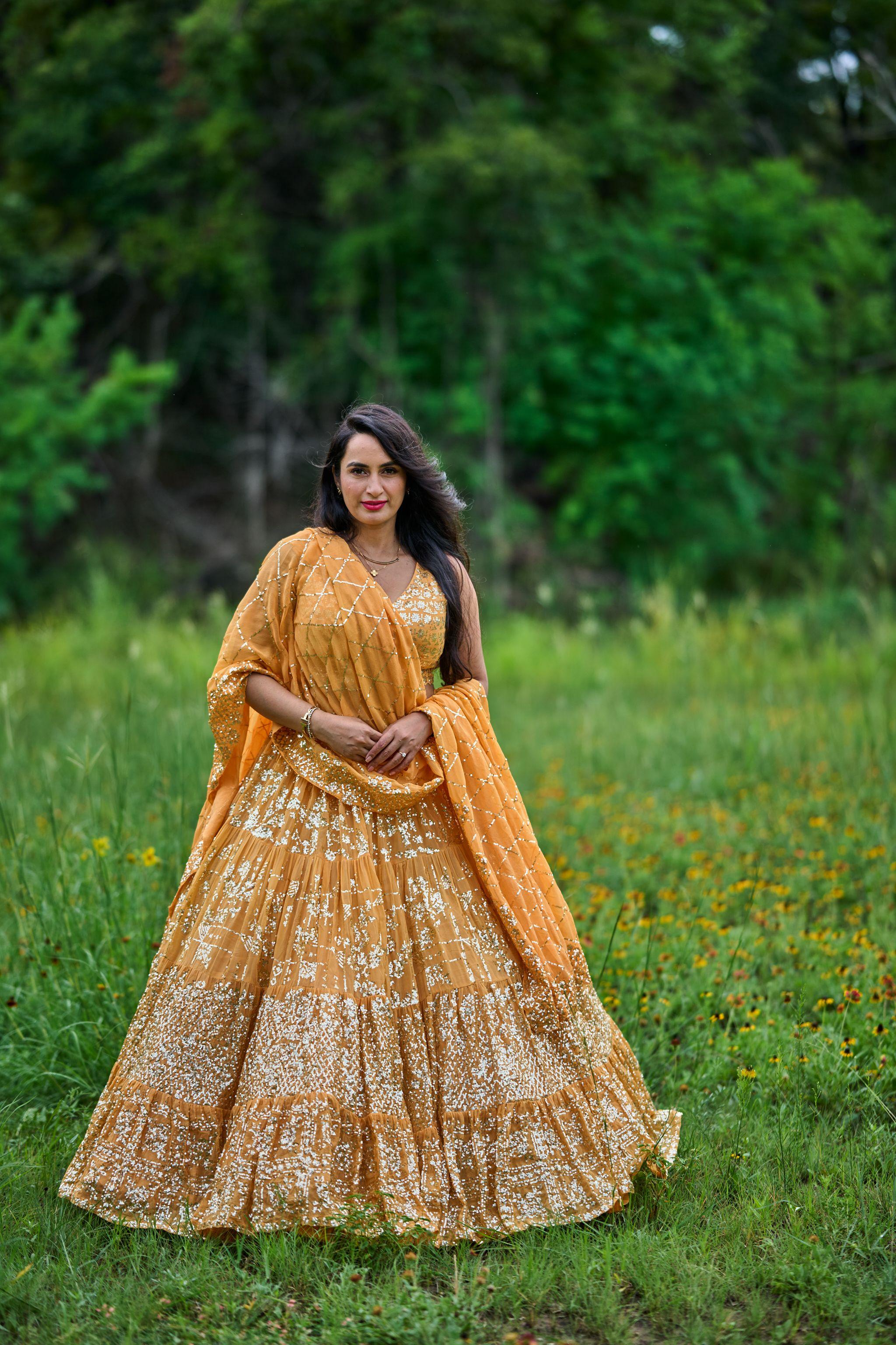 Woman in gold standing in the wildflower meadow at the edge of the Cedar Park library grounds — Cedar Park Public Library photography, Austin A woman in gold standing in the wildflower meadow at the edge of the Cedar Park library grounds