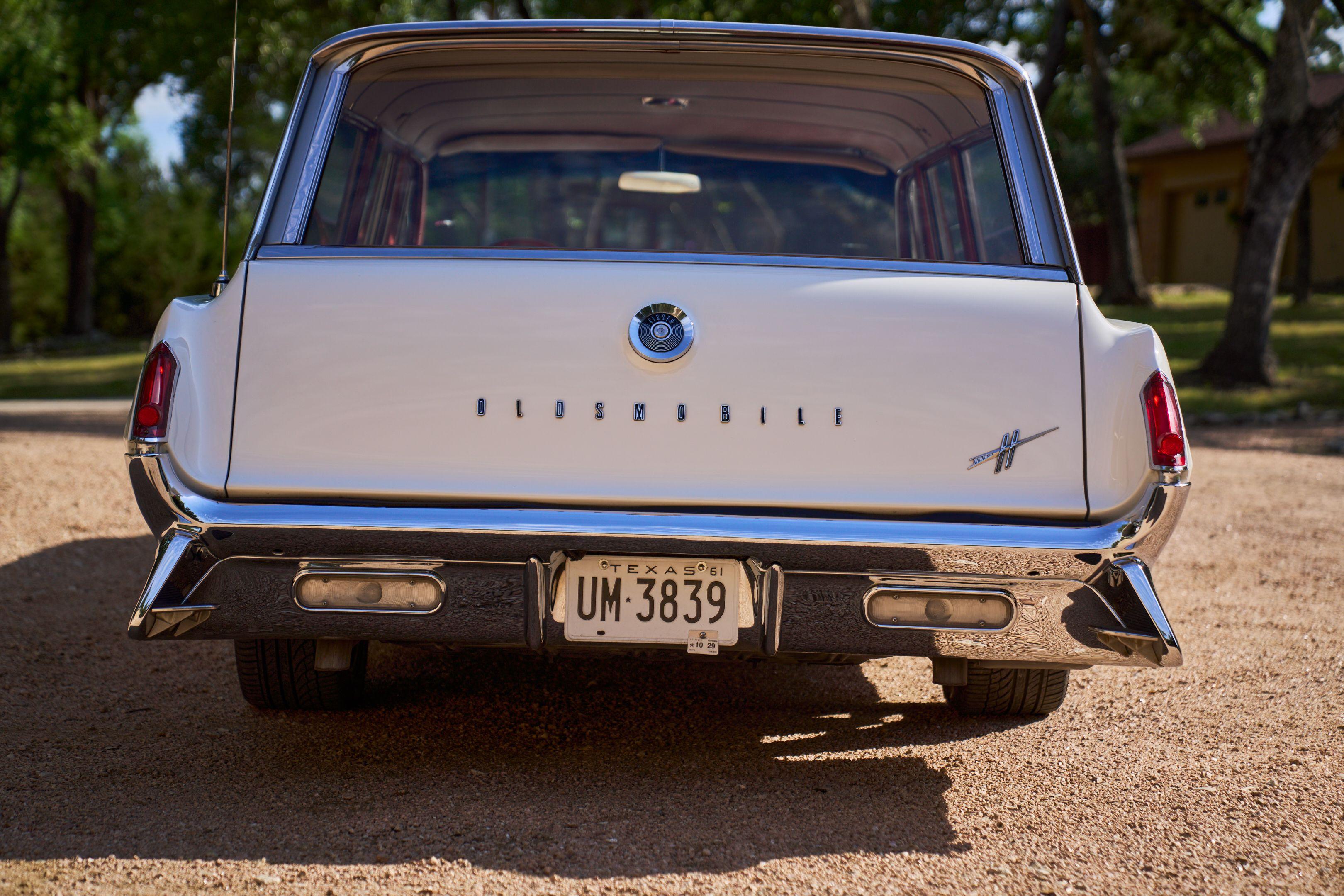 Rear of a classic Oldsmobile with chrome trim and a Texas license plate — Automotive photography, Austin The rear of a classic Oldsmobile with chrome trim and a Texas license plate.