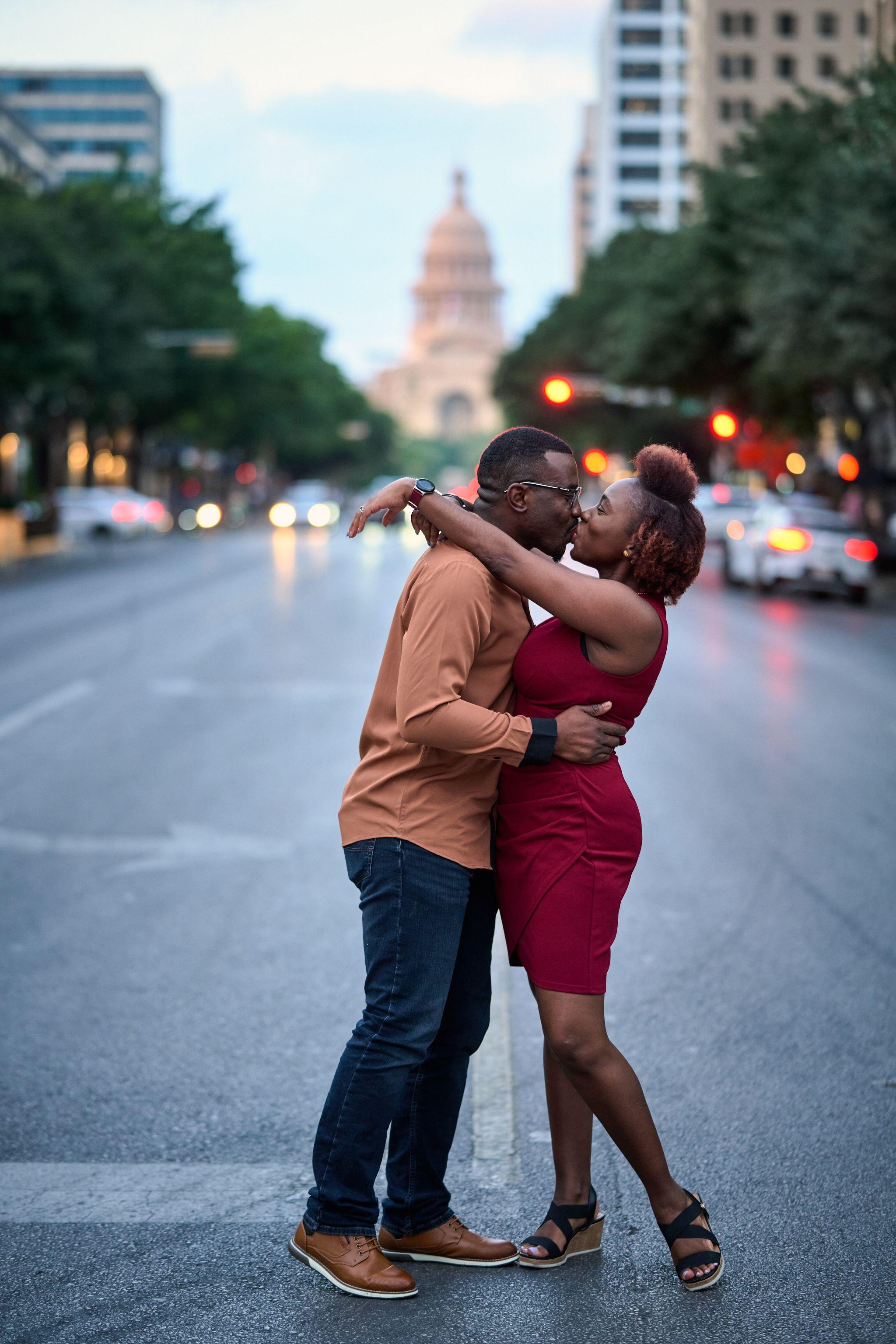 Couple embracing in the middle of Congress Avenue at dusk, the Capitol dome lit — Congress Avenue photography, Austin A couple embracing in the middle of Congress Avenue at dusk, the Capitol dome lit at the end of the street.