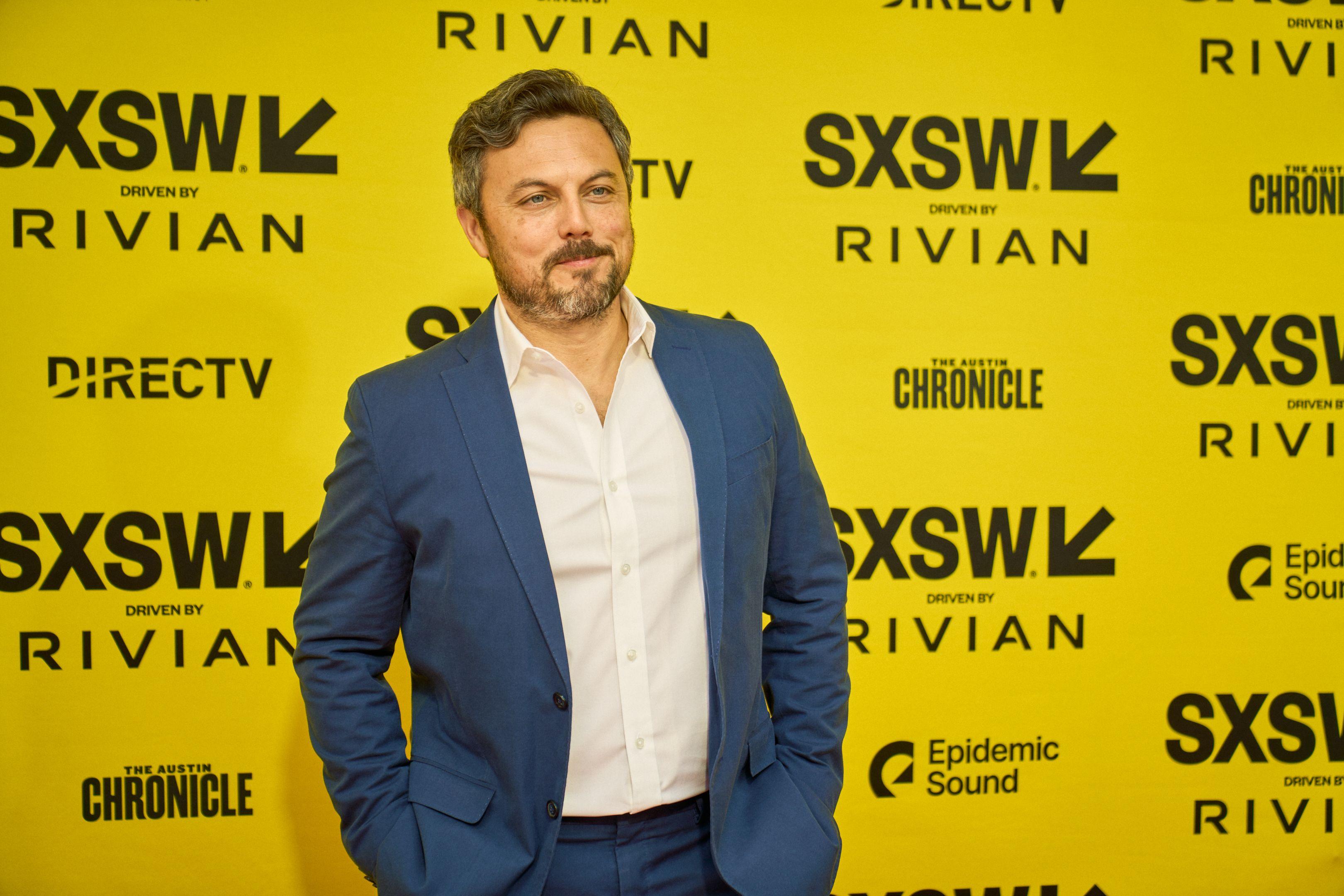 Man in a blue jacket and open-collar shirt posing on the SXSW red carpet — Production behind-the-scenes, Austin Man in a blue jacket and open-collar shirt posing on the SXSW red carpet