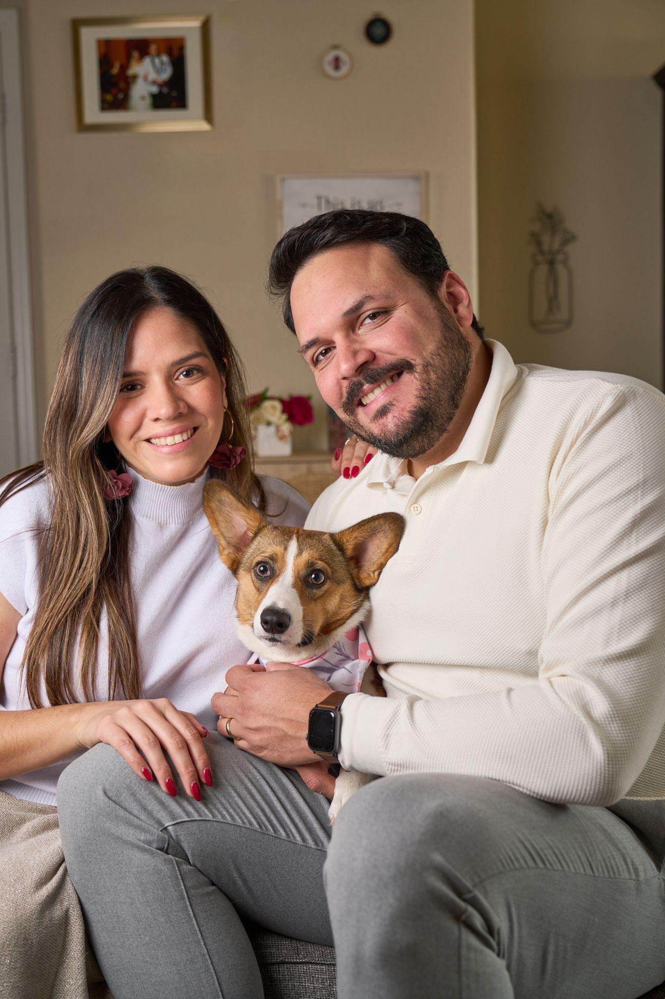 Couple on a sofa holding their small brown and white dog — Pet Photography photography, Austin A couple on a sofa holding their small brown and white dog.