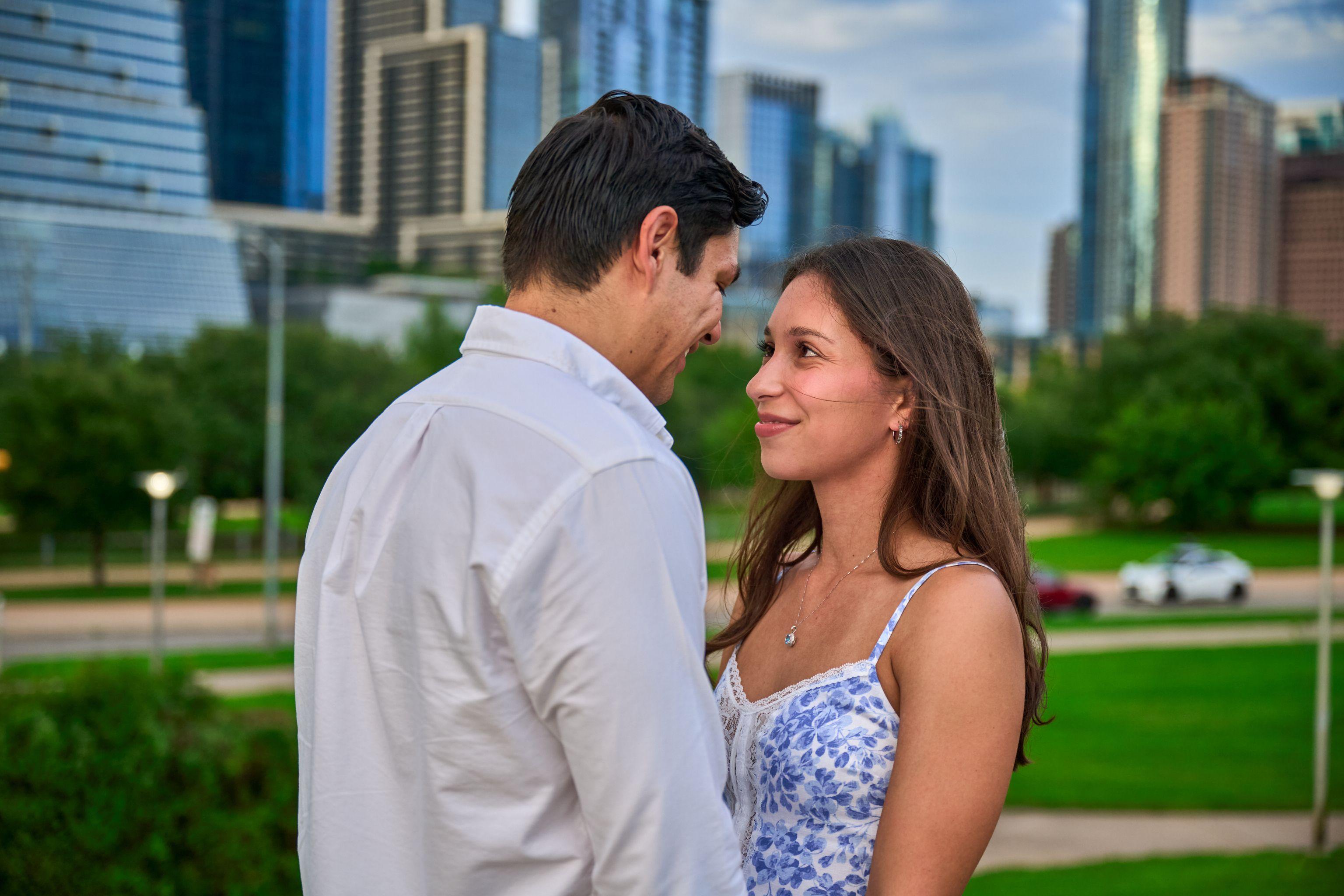 Couple looking at each other in front of the downtown Austin towers — Butler Metro Park photography, Austin A couple looking at each other in front of the downtown Austin towers.