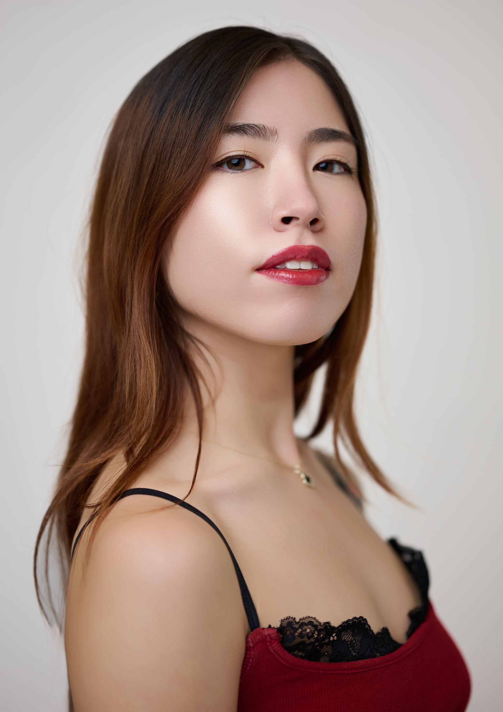 Close studio portrait of a woman with red lipstick and a dark top — Photo retouching, Austin A close studio portrait of a woman with red lipstick and a dark top.