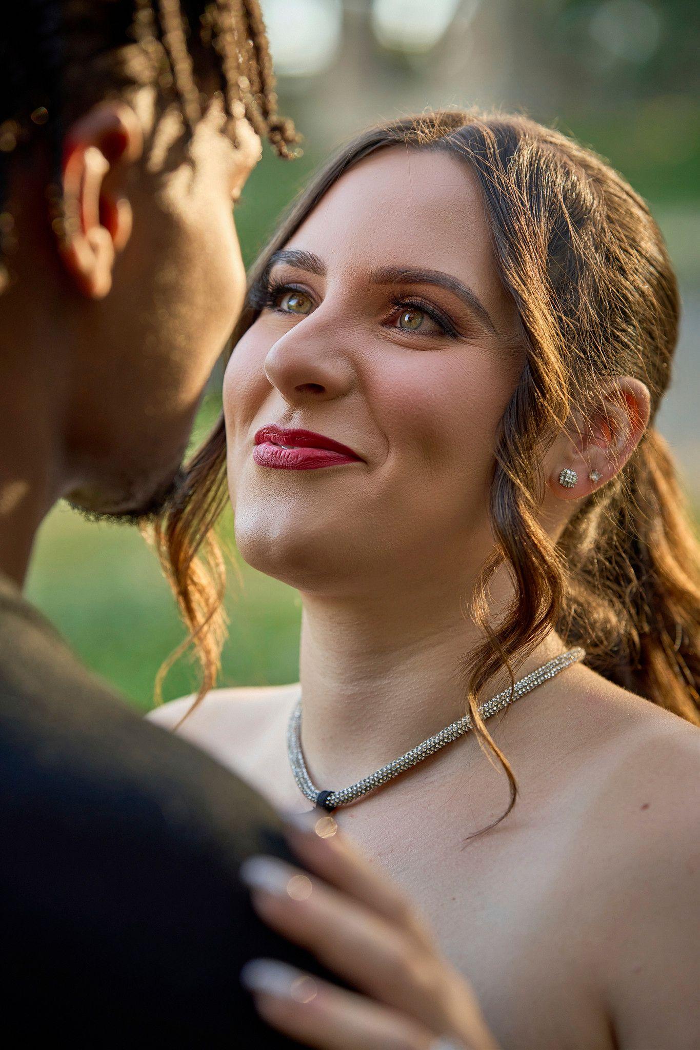 Bride laughing in golden light, the groom's silhouette in the foreground — Photo retouching, Austin A bride laughing in golden light, the groom's silhouette in the foreground.