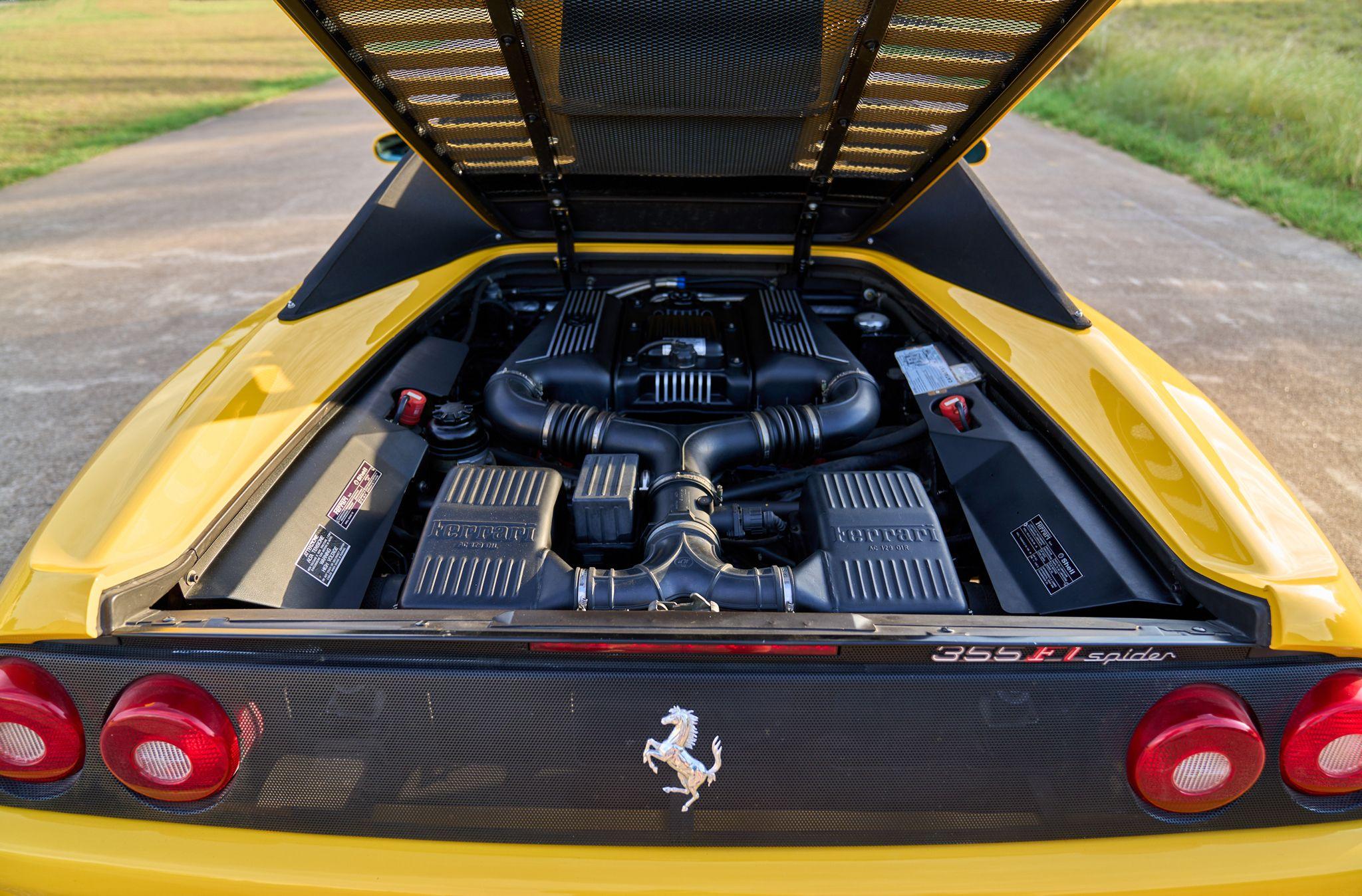 Exposed V8 engine bay of a yellow Ferrari 355 with the rear hatch raised — Automotive photography, Austin The exposed V8 engine bay of a yellow Ferrari 355 with the rear hatch raised.