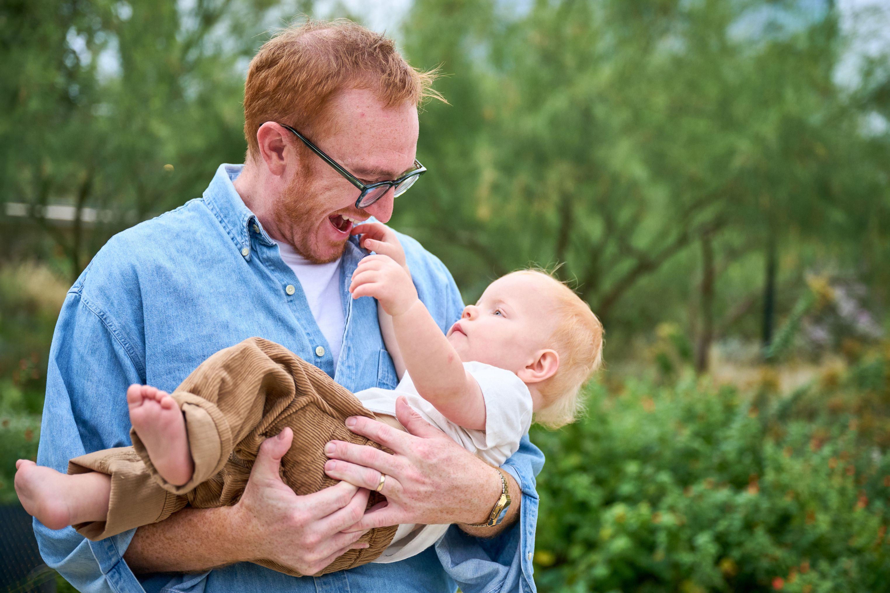 Father in glasses laughing as his baby reaches for his face — Waterloo Park photography, Austin A father in glasses laughing as his baby reaches for his face.