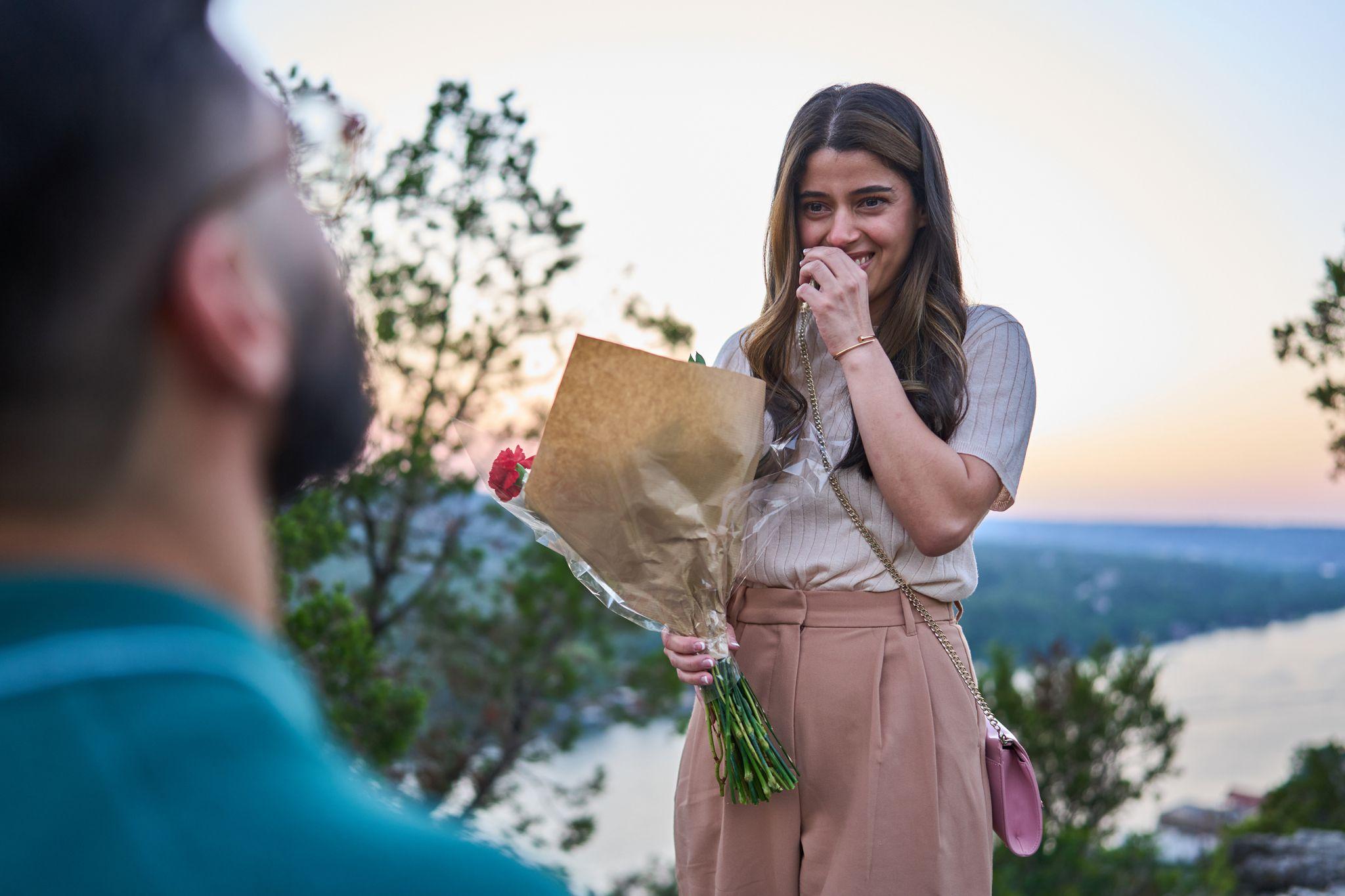 Woman reacting with surprise and holding a bouquet at a proposal — Mount Bonnell portraits, Austin Woman reacting with surprise and holding a bouquet at a proposal