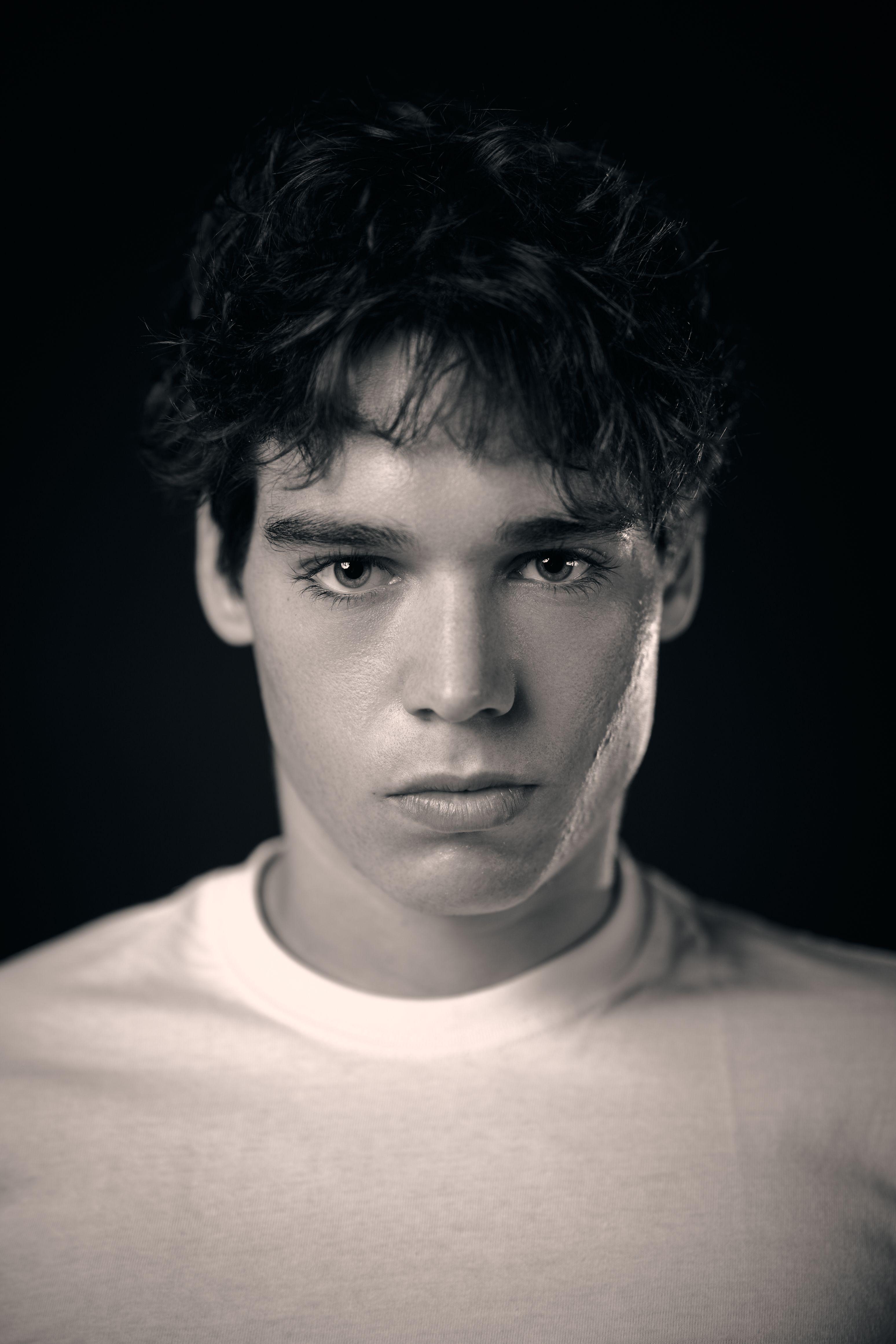 Black and white studio headshot of a young actor in a white t-shirt — Headshot photography, Austin A black and white studio headshot of a young actor in a white t-shirt.