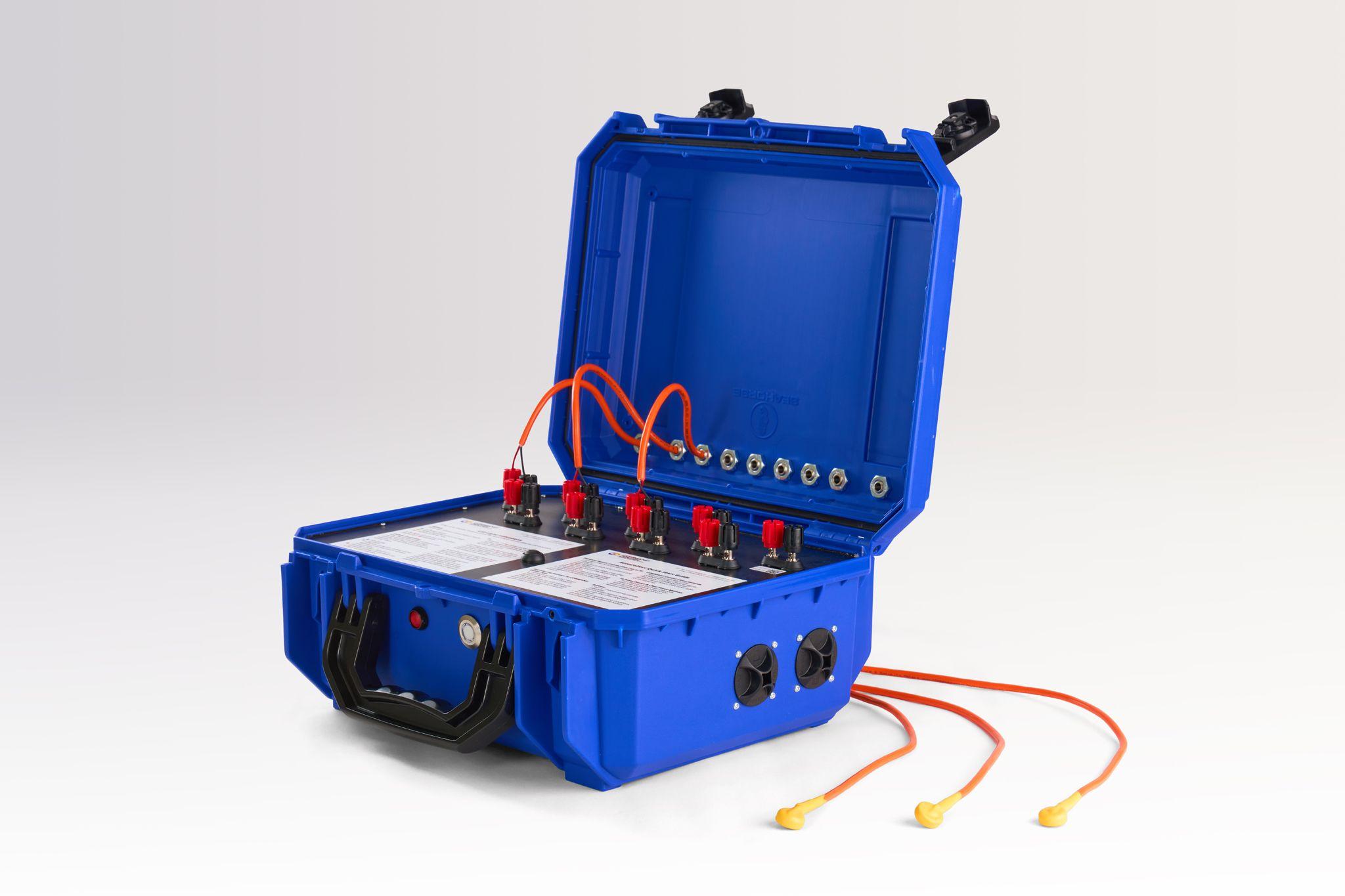 Open blue hard equipment case with orange cabling coiled inside — Product photography, Austin An open blue hard equipment case with orange cabling coiled inside.