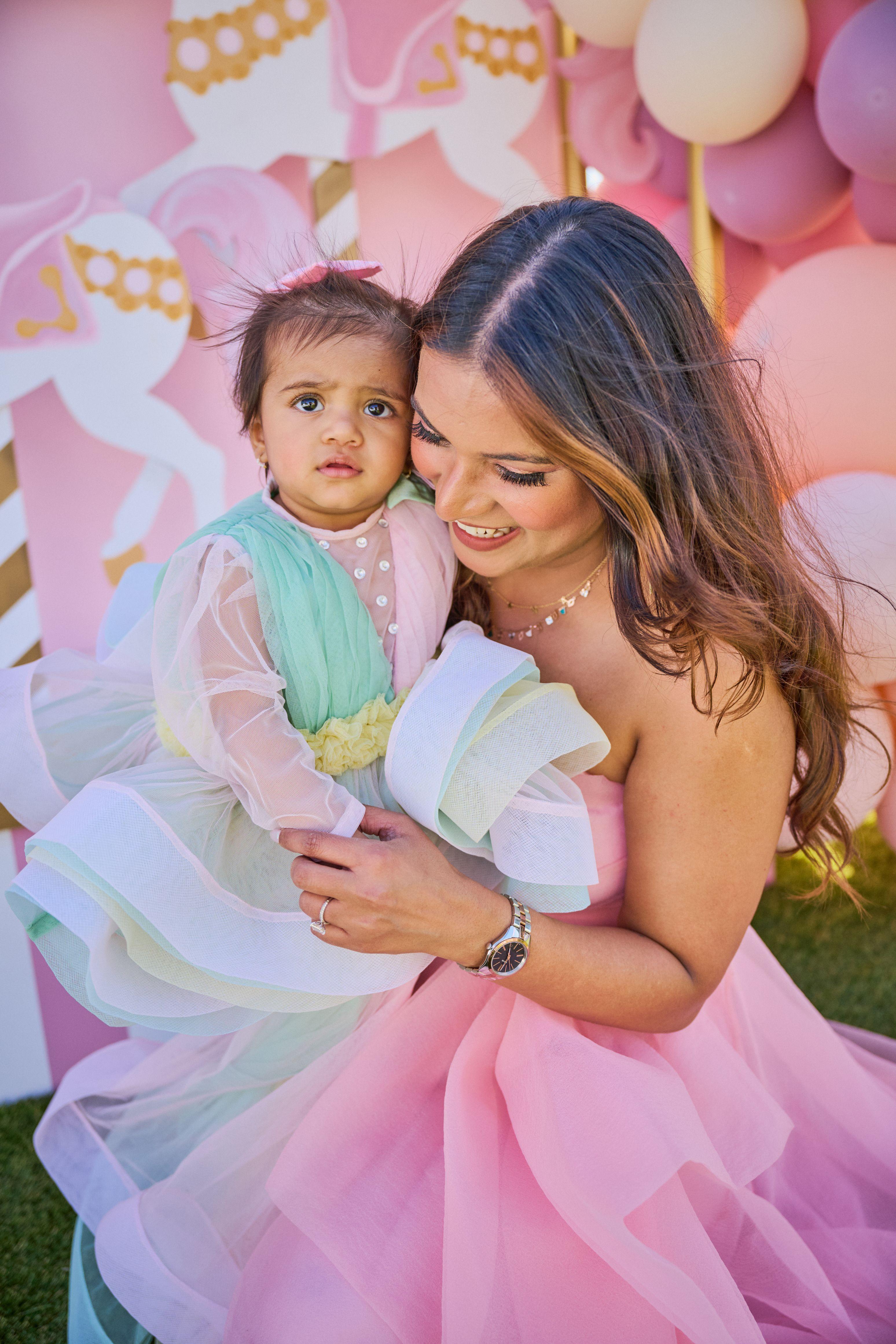 Mother in a tulle gown holding her toddler, both in pastel party dresses — Family Parties photography, Austin A mother in a tulle gown holding her toddler, both in pastel party dresses.