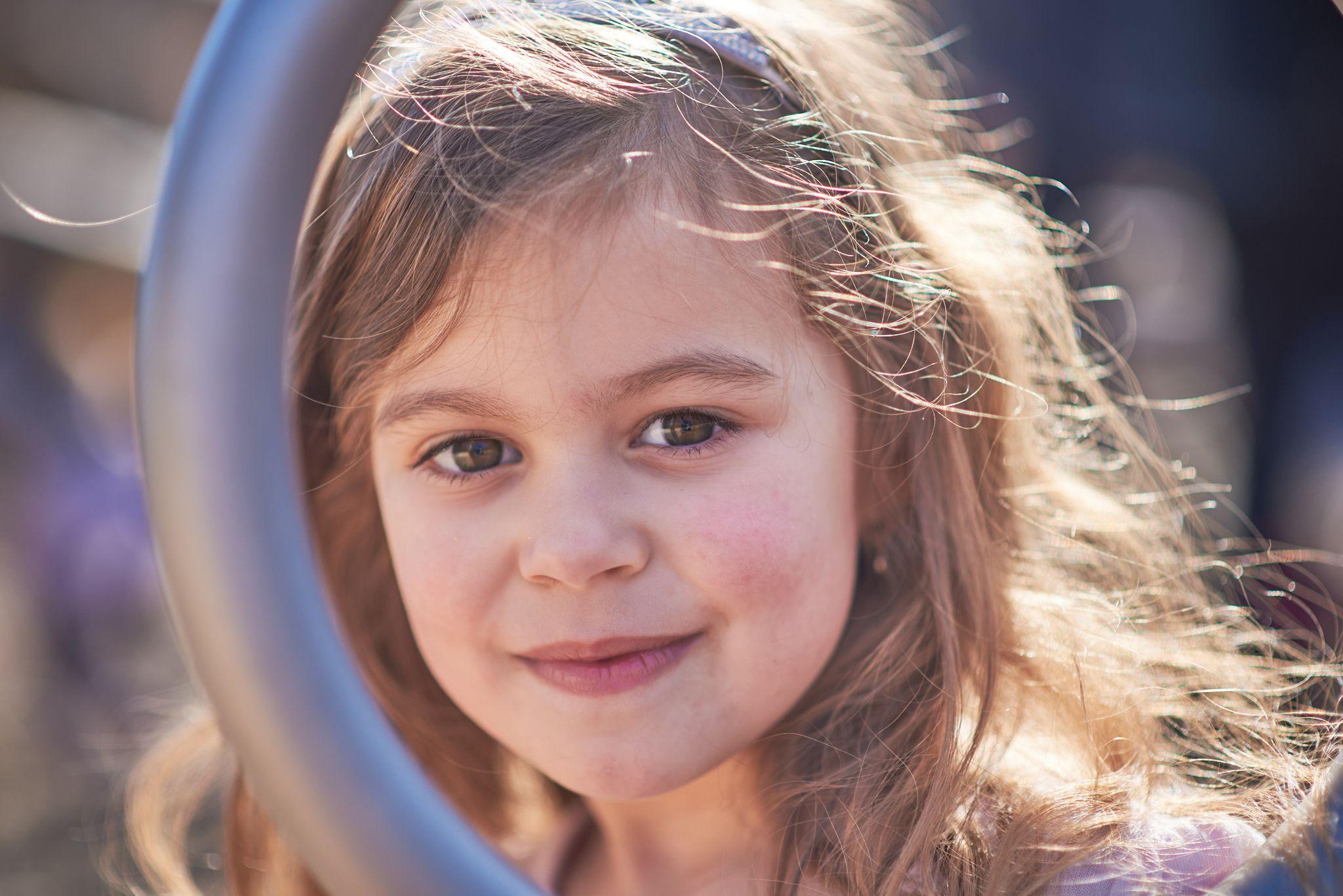 Young girl backlit by afternoon sun in Pease Park, her hair lit at the edges — Pease Park photography, Austin A young girl backlit by afternoon sun in Pease Park, her hair lit at the edges
