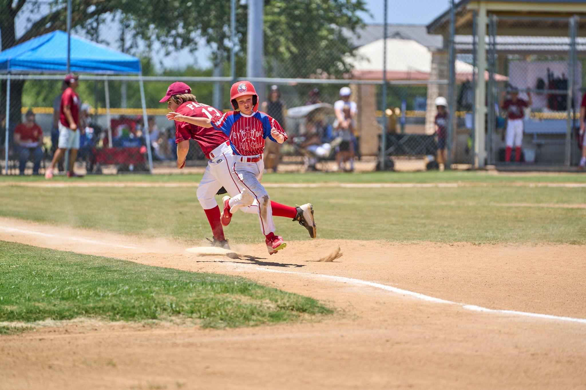 Softball player sliding into a base as the fielder reaches for the tag — Sports photography, Austin Softball player sliding into a base as the fielder reaches for the tag