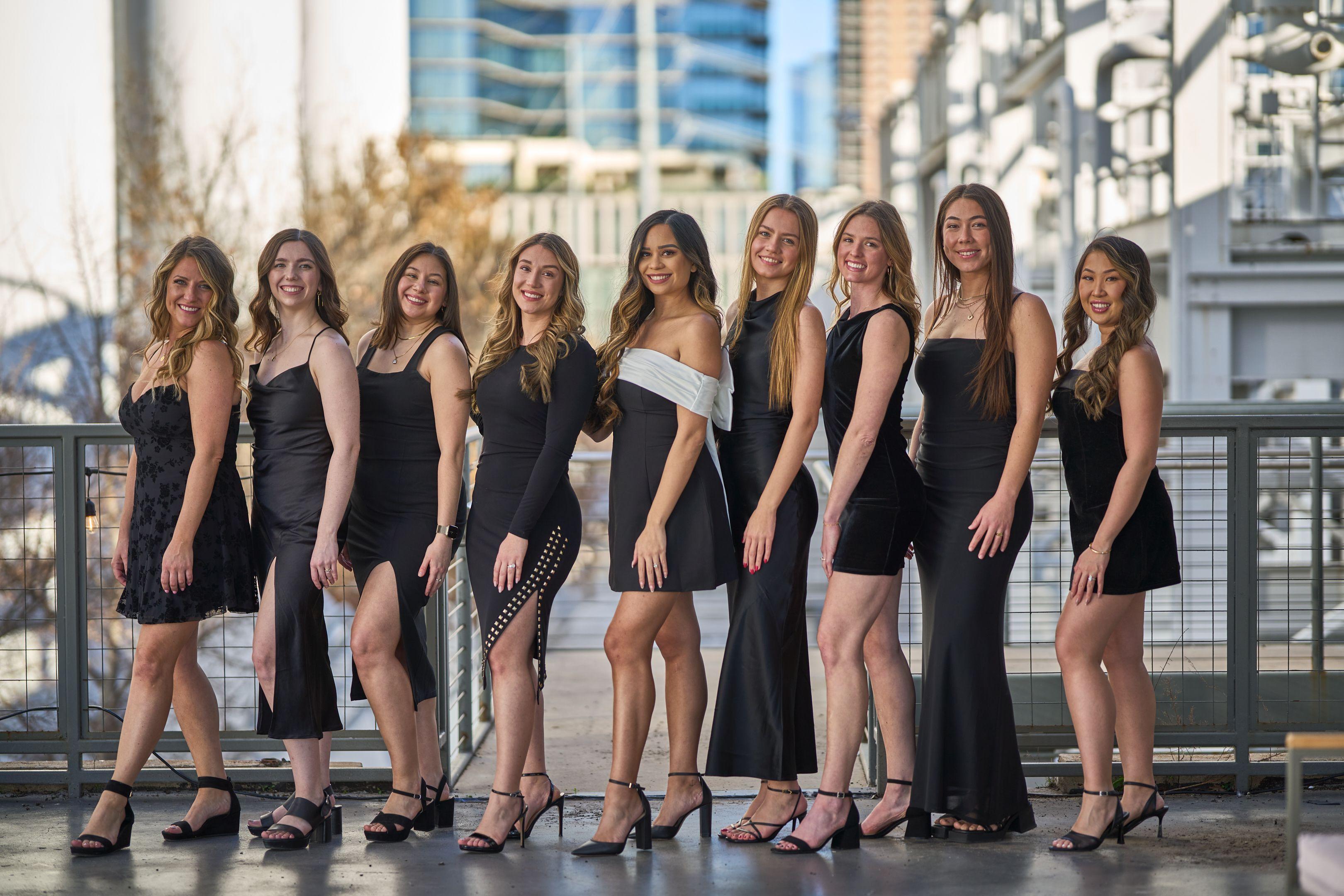 Bachelorette party in matching black dresses lined up along a downtown boardwalk — Bachelor & Bachelorette photography, Austin A bachelorette party in matching black dresses lined up along a downtown boardwalk.