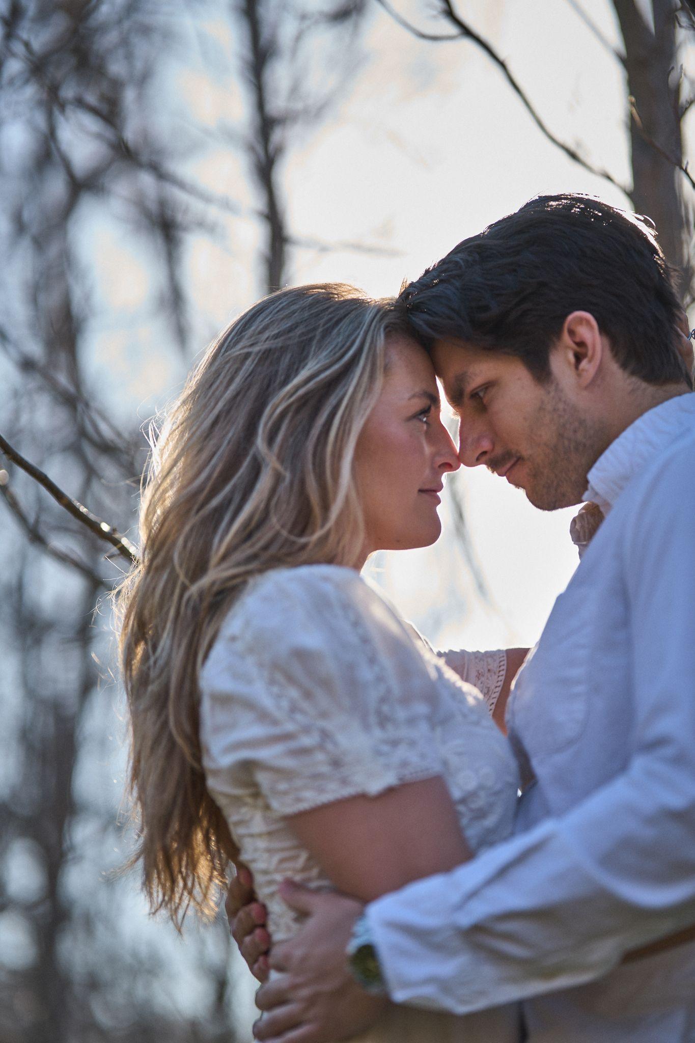 Couple resting their foreheads together among bare winter branches — Commons Ford Ranch photography, Austin A couple resting their foreheads together among bare winter branches.